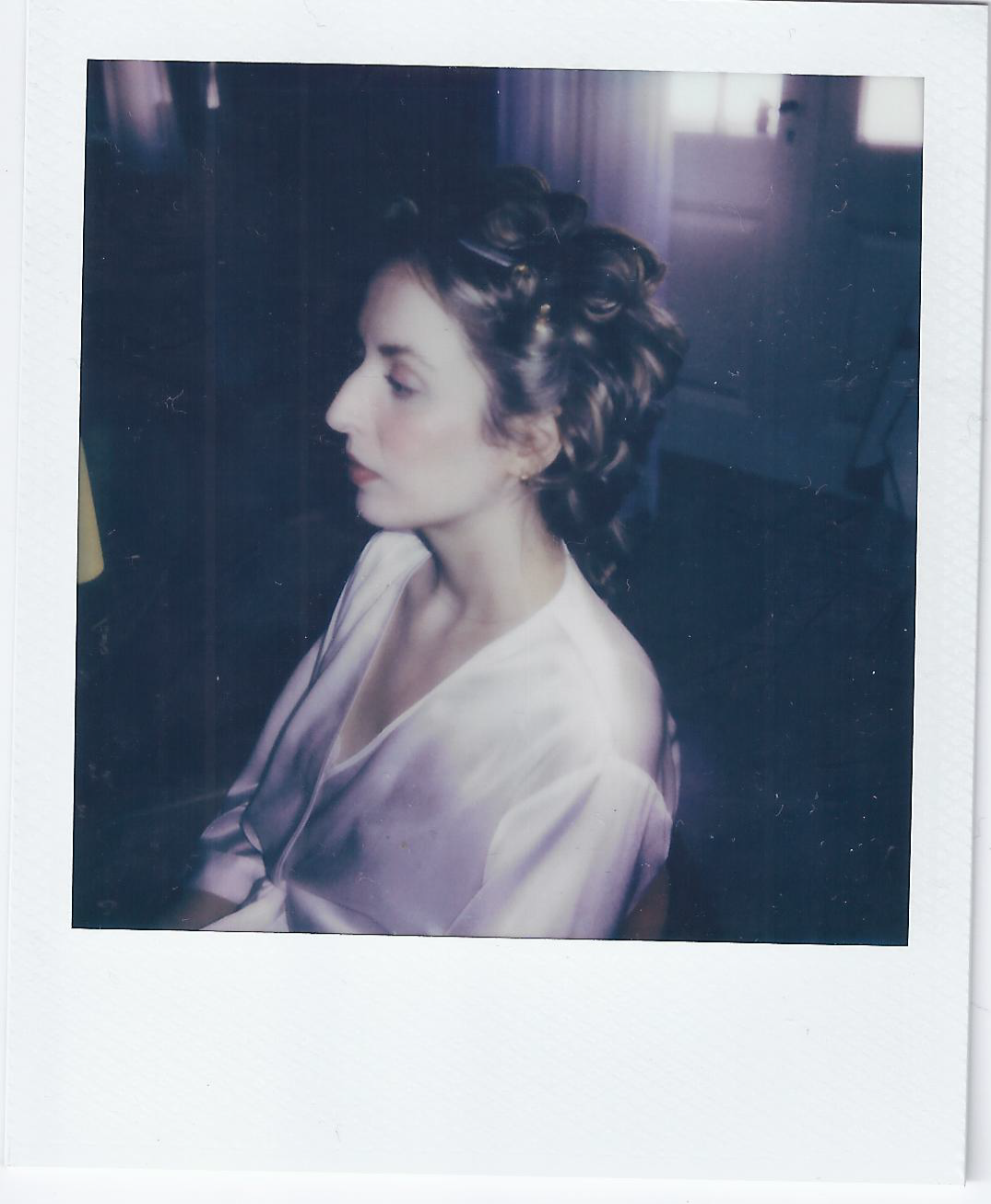 Vintage-style polaroid photographs arranged in a row showing artistic portraits.