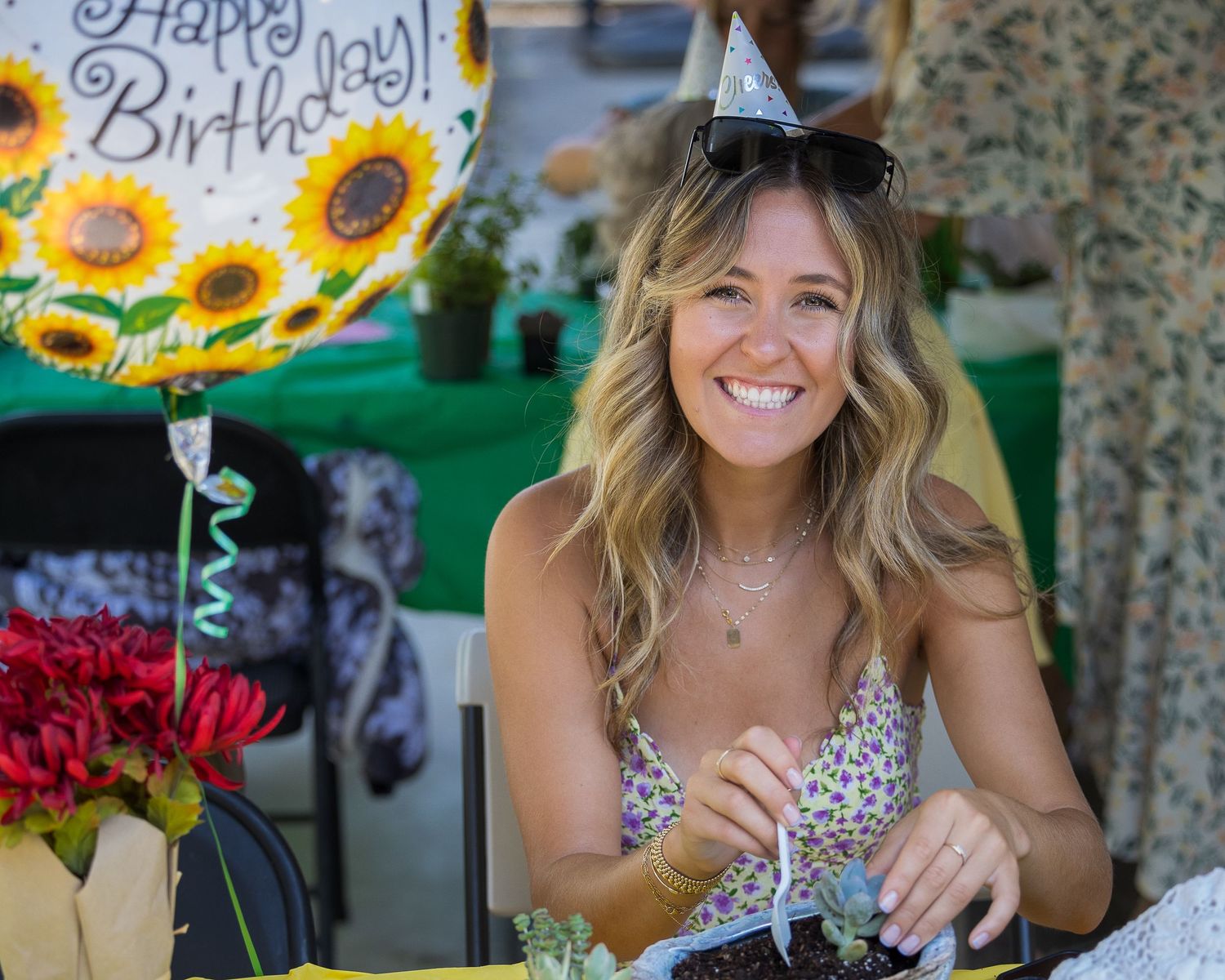 Beautiful woman repotting a plant at a garden birthday party!