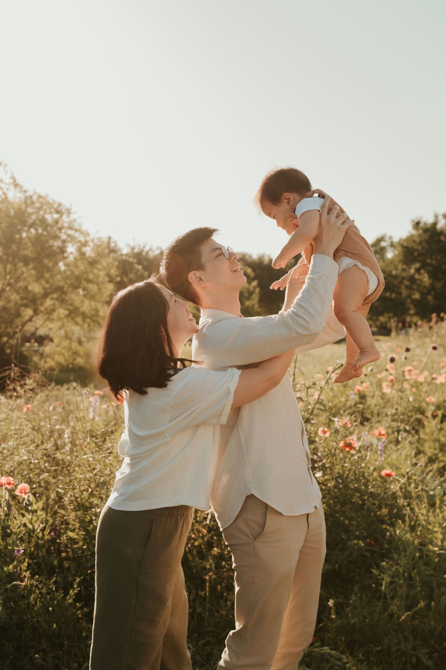 Couple dancing in a sunlit wildflower meadow at golden hour captured in three ethereal moments.