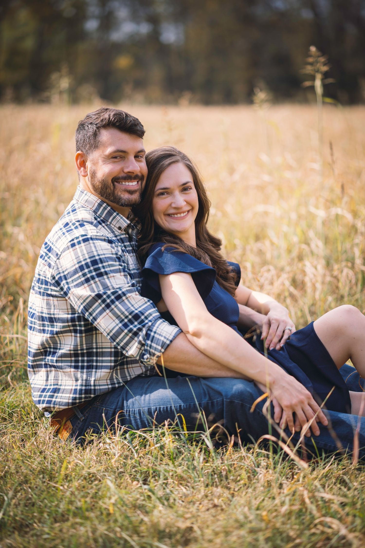 Couple enjoy a picnic in this custom Lifestyle Session. The tall grass soften in the bokeh, creating depth in this portrait.
