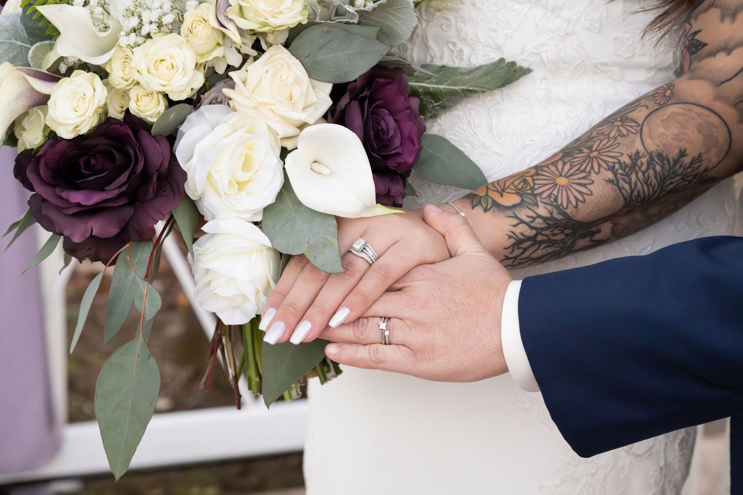 Brides share a moment post-ceremony photos: rings with bouquet. LGBTQ+ friendly photographers.