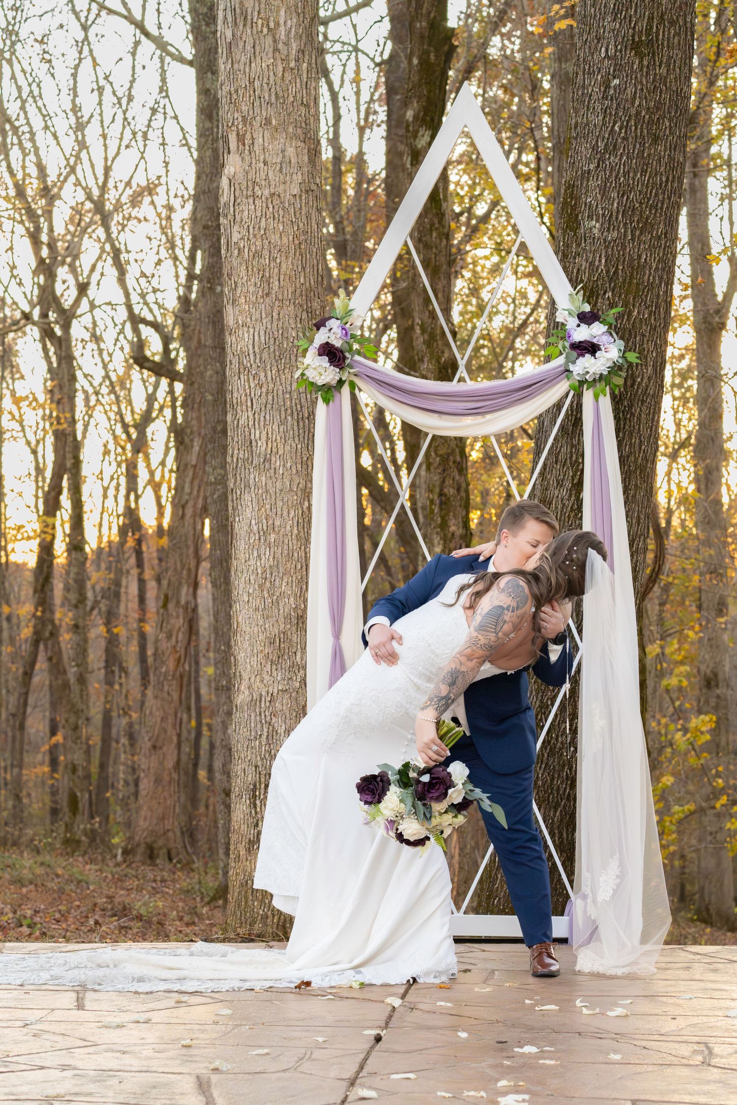 Bride dips and kisses her bride in this LGBTQ+ fall wedding. LGBTQ+ friendly photographers