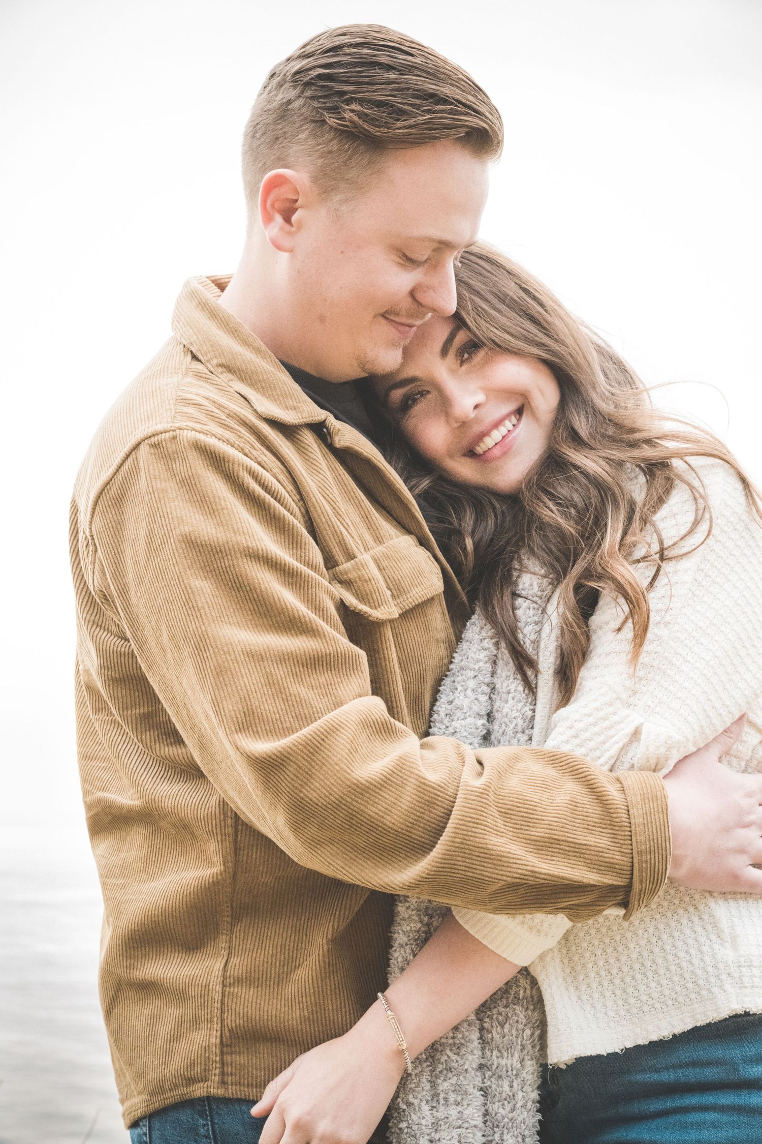 Couple embrace as Robinson Photography captures pure joy on her face: Pacific Coast, Big Sur, California.