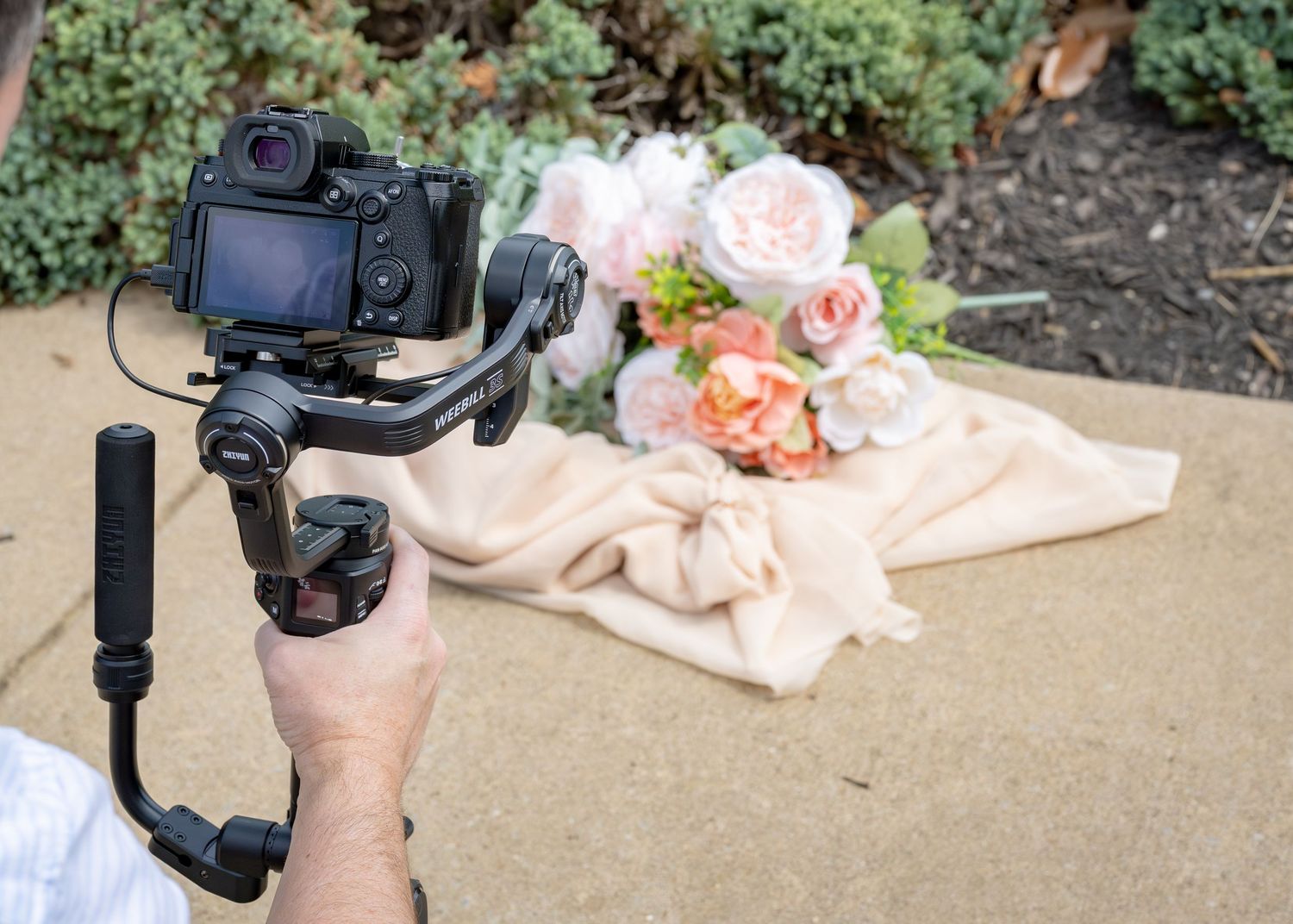Wedding Videography Services captures soft pink bouquet and wedding rings