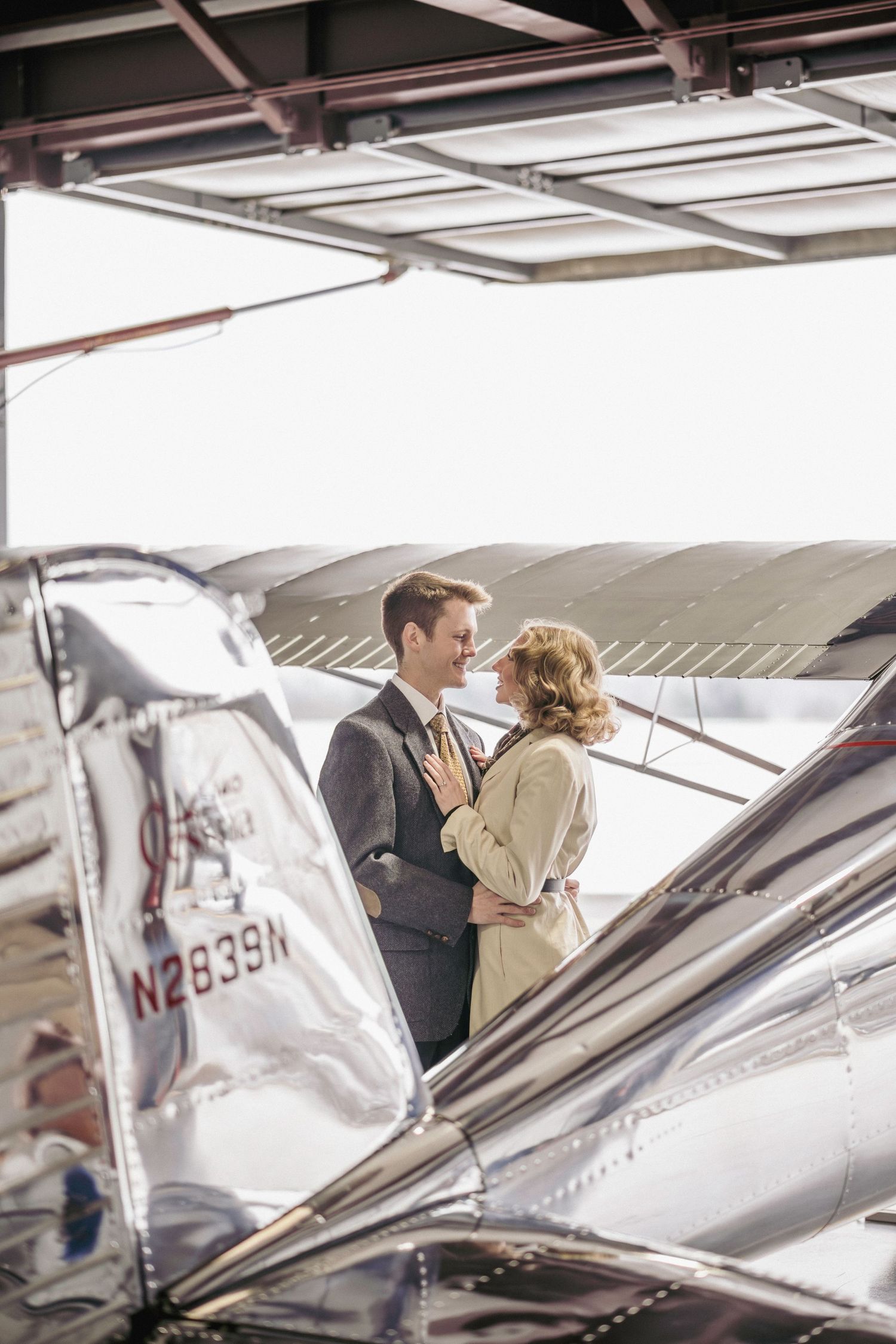 Tender Embrace: Vintage Cessna Aircraft used during a vintage engagement session. Connect with us today to begin your custom journey!