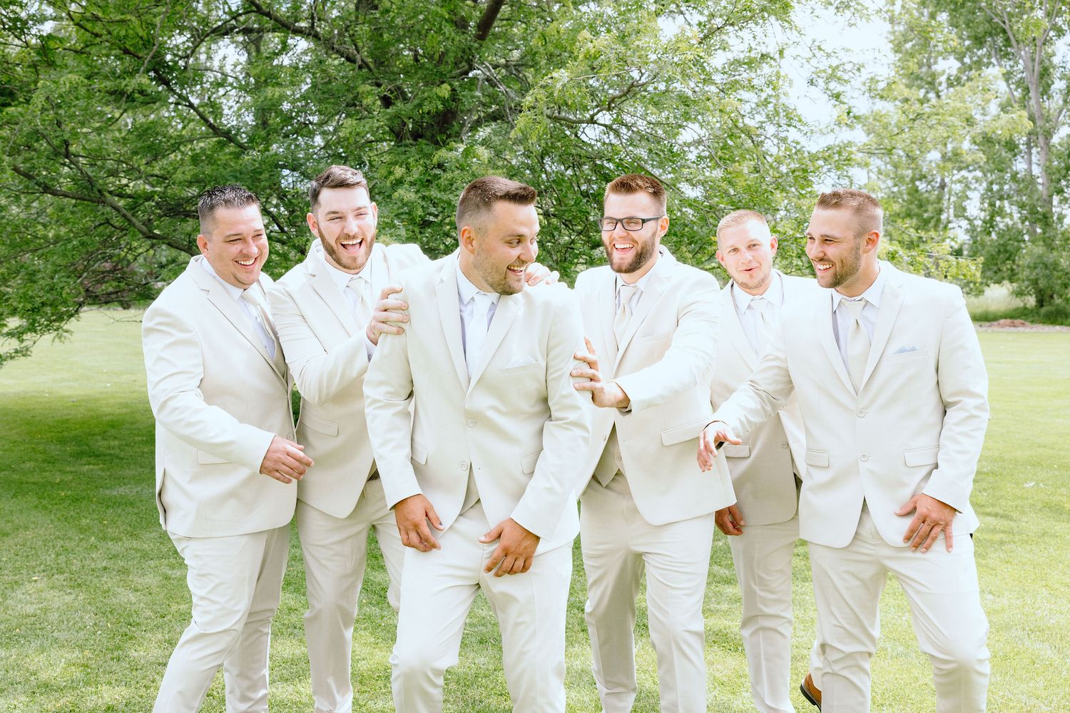 Groomsmen walking at Lapeer Country Club wedding in Michigan