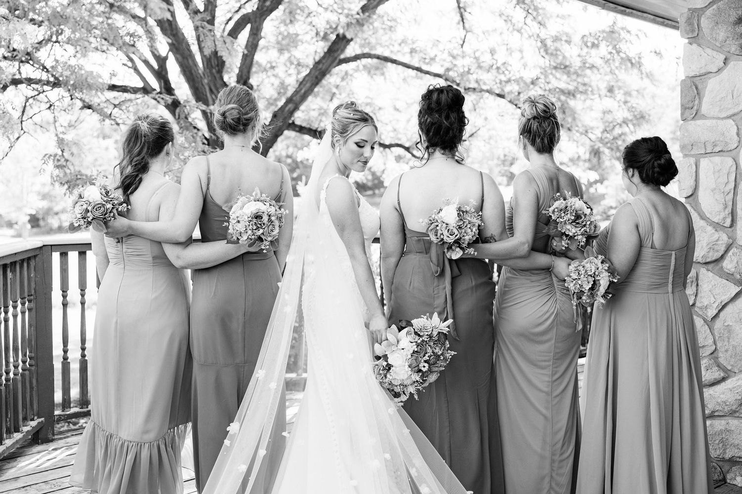 Bride and bridesmaids standing in a line at Lapeer Country Club wedding in Michigan