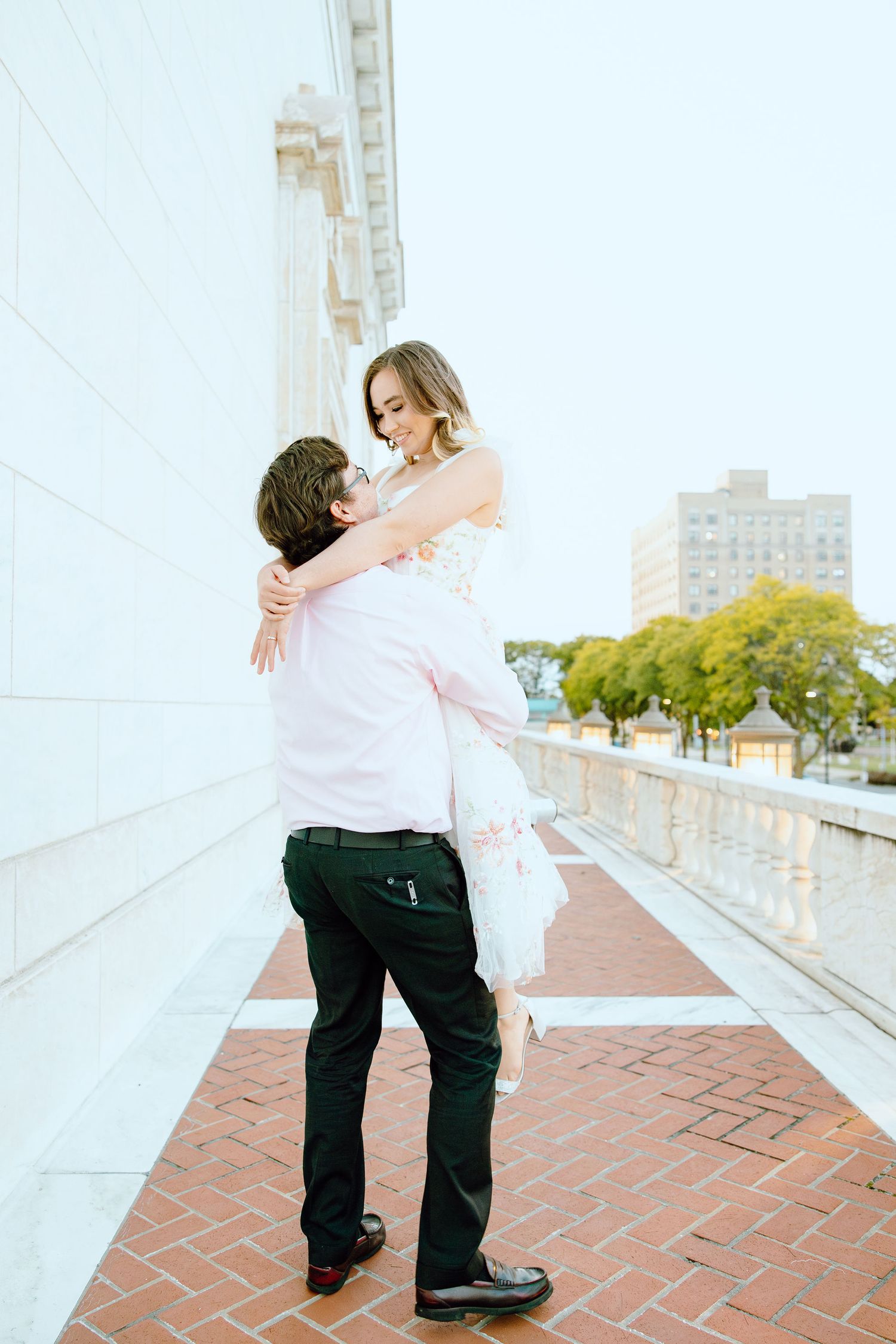 Man lifting woman at Detroit Institute of Arts engagement session in Detroit, MI