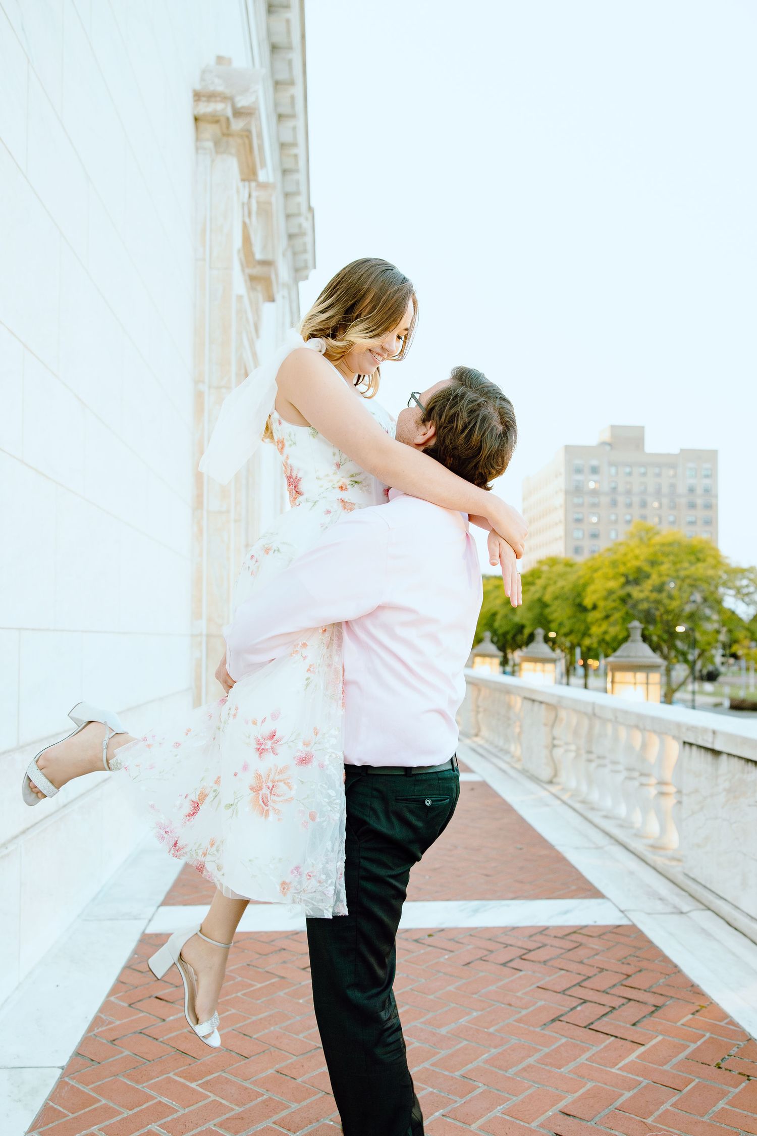 Man lifting woman at Detroit Institute of Arts engagement session in Detroit, MI