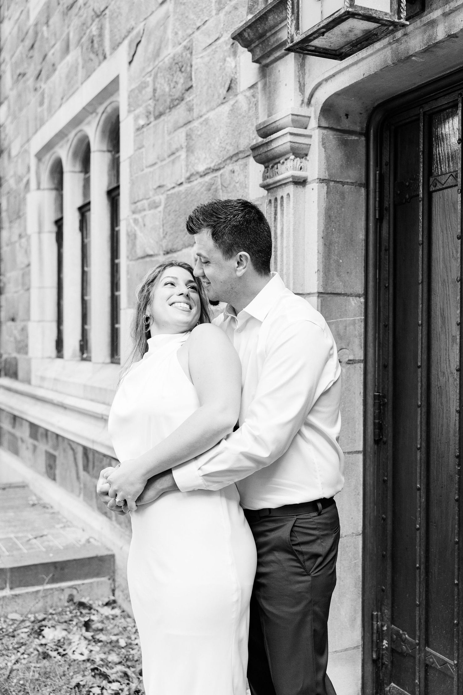 Engaged couple embracing at the University of Michigan Law Quad engagement session in Ann Arbor, MI