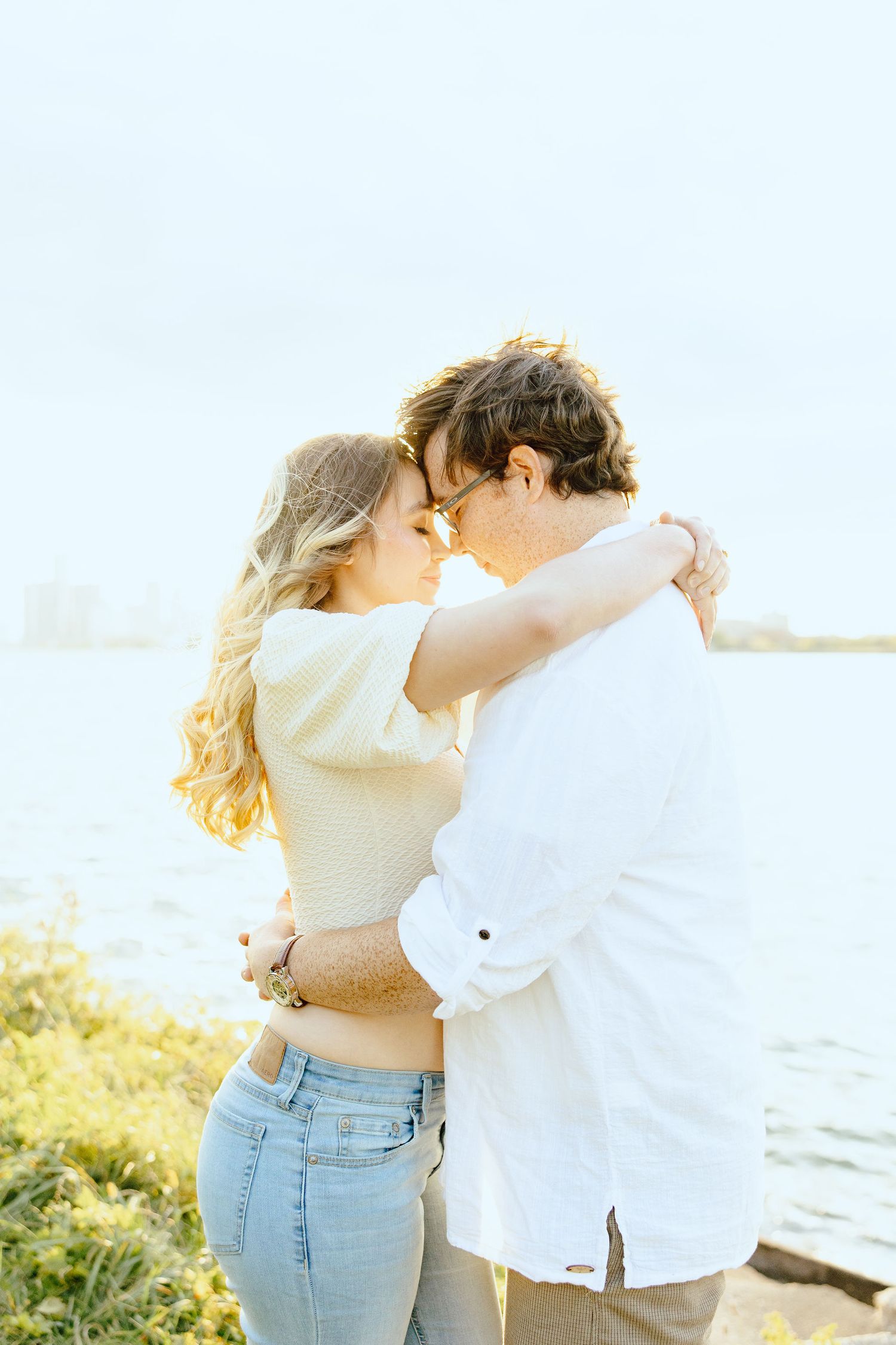 Engaged couple embracing at Belle Isle summer engagement session in Detroit, MI