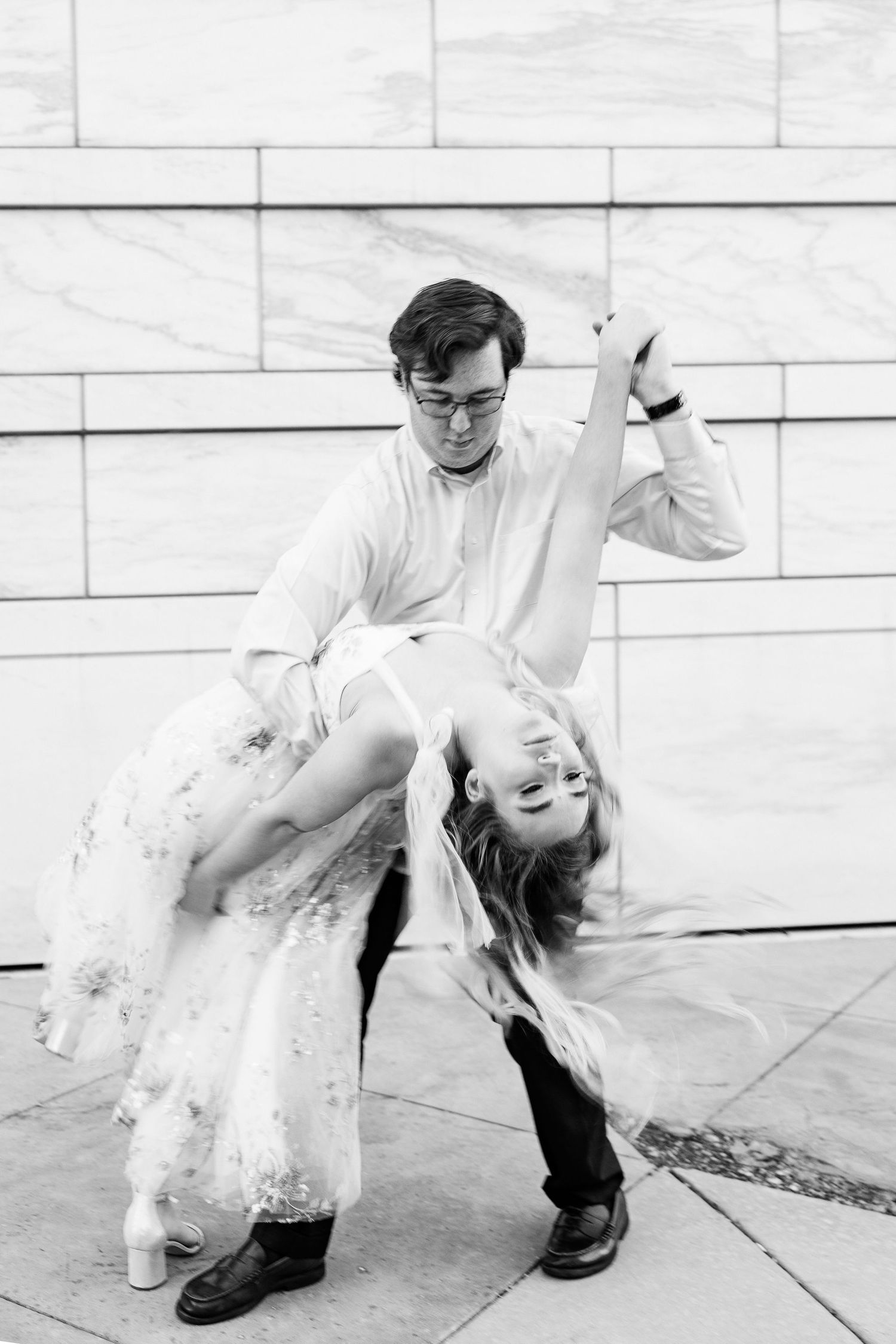 Engaged couple swing dancing at Detroit Institute of Arts engagement session in Detroit, MI