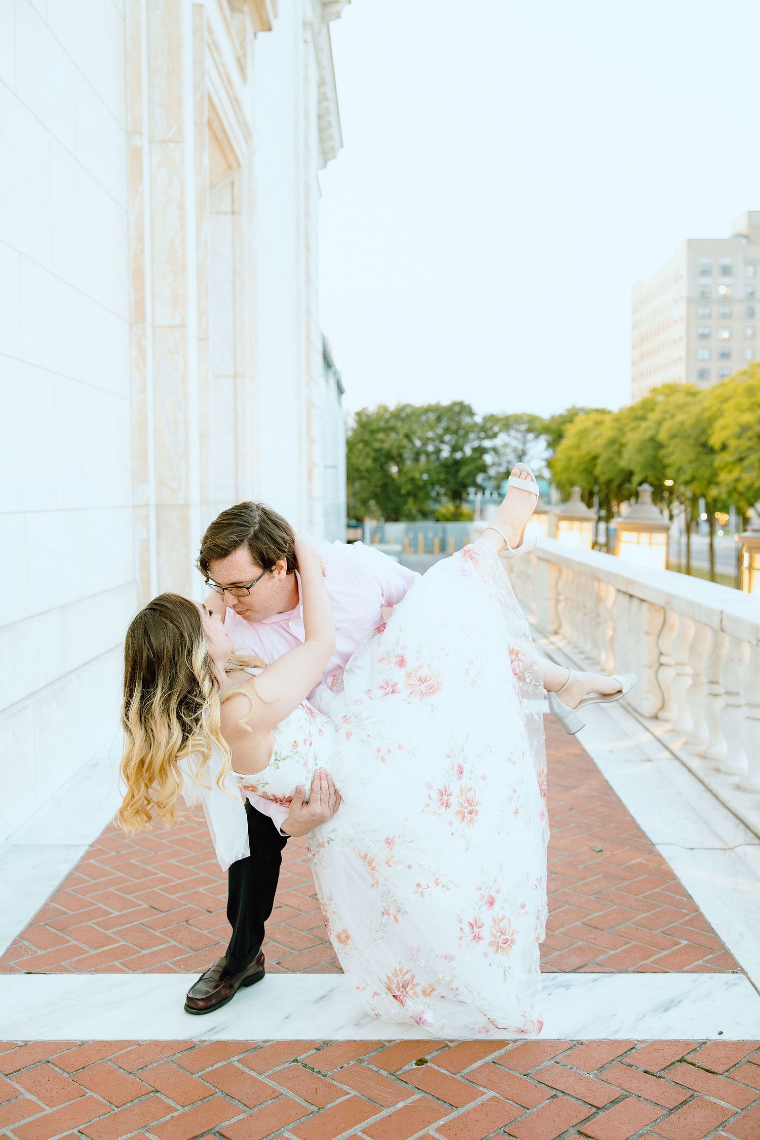 Man lifting woman at Detroit Institute of Arts engagement session in Detroit, MI