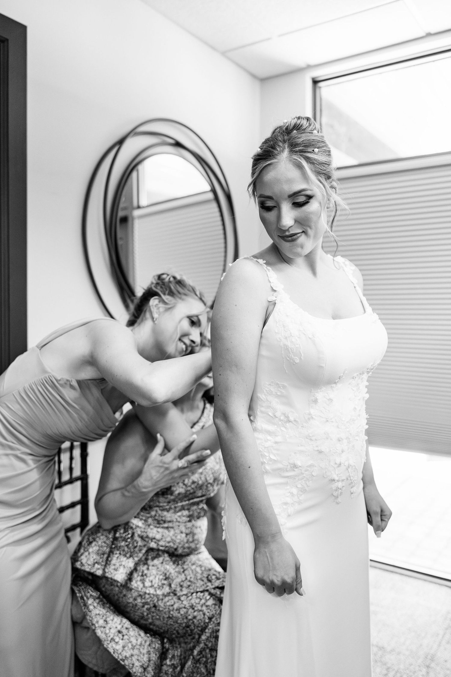 Bride getting into dress at Lapeer Country Club wedding in Michigan