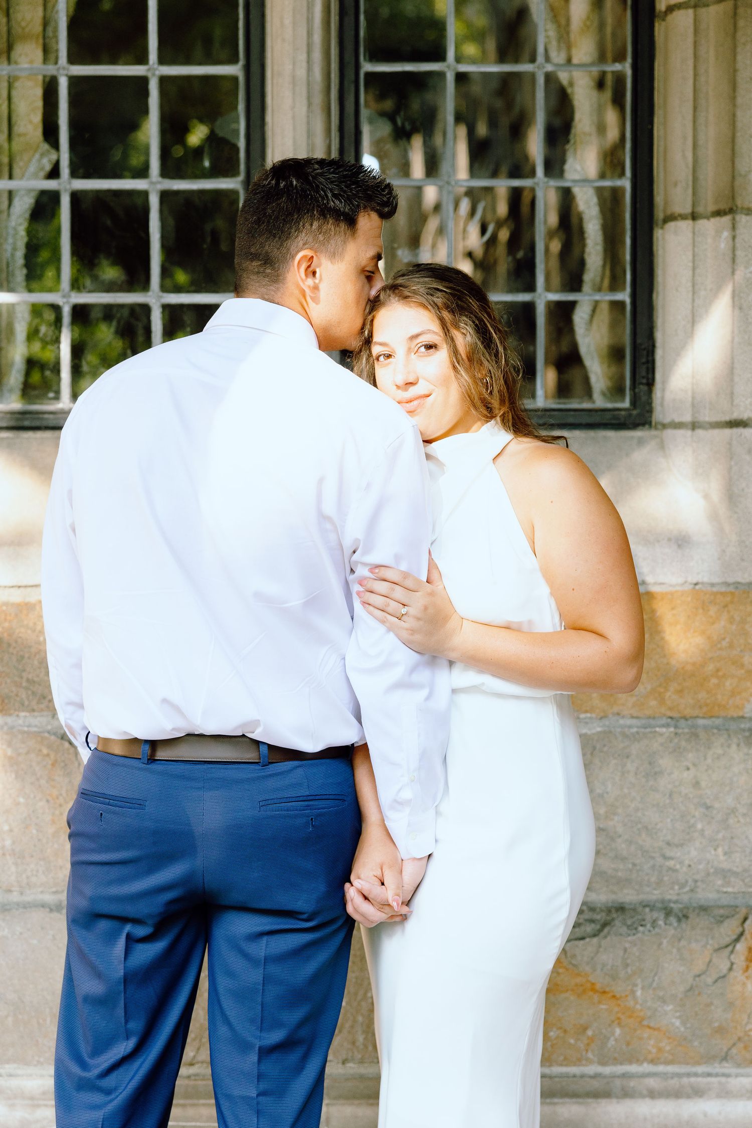 Engaged couple embracing at the University of Michigan Law Quad engagement session in Ann Arbor, MI