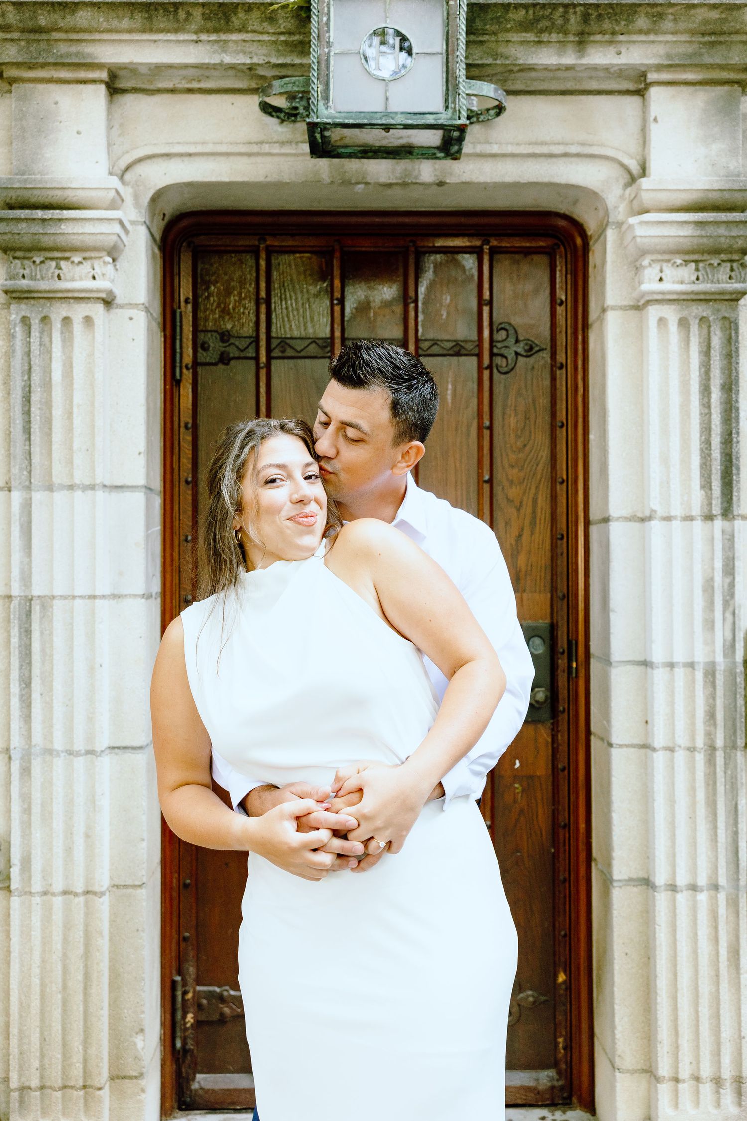 Engaged couple embracing at the University of Michigan Law Quad engagement session in Ann Arbor, MI