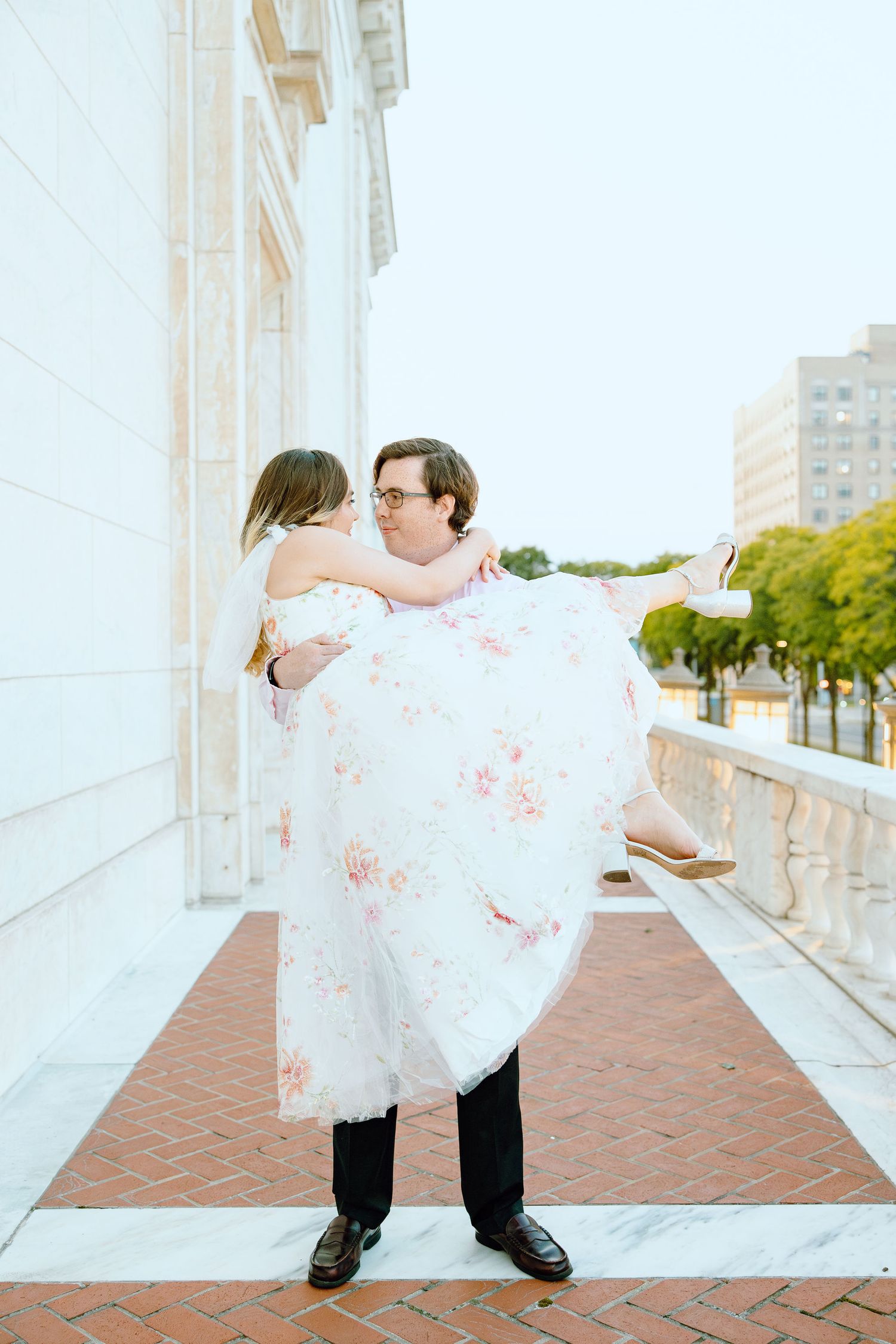 Man lifting woman at Detroit Institute of Arts engagement session in Detroit, MI