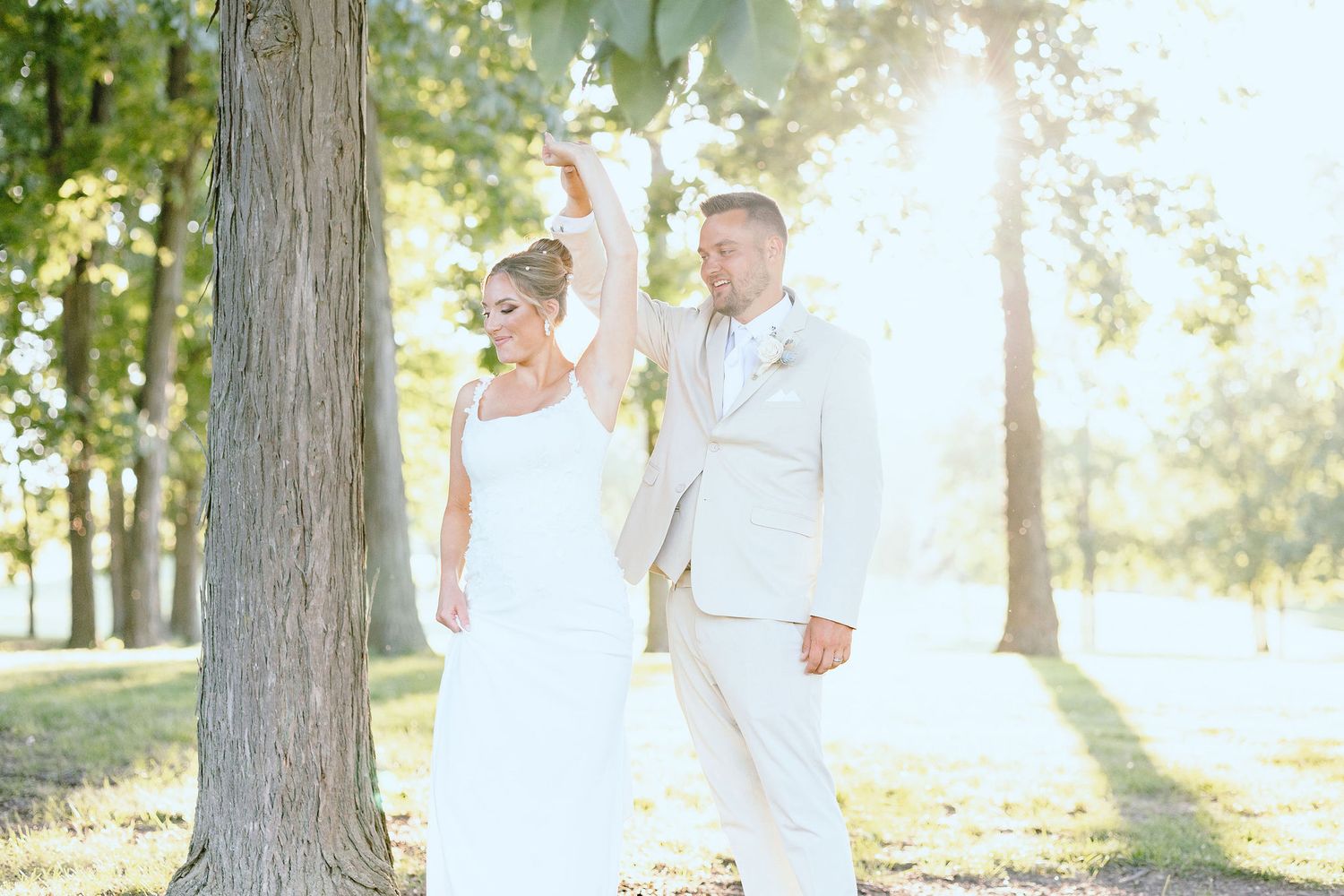 Married couple twirling during golden hour at Lapeer Country Club wedding in Michigan