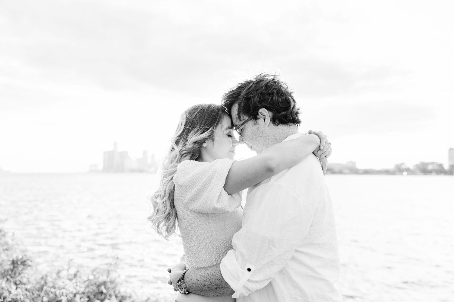 Engaged couple embracing at Belle Isle summer engagement session in Detroit, MI