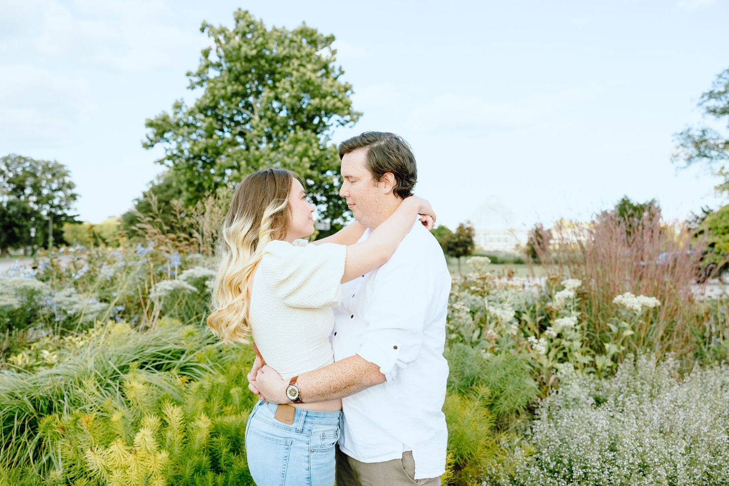 Engaged couple embracing at Belle Isle summer engagement session in Detroit, MI