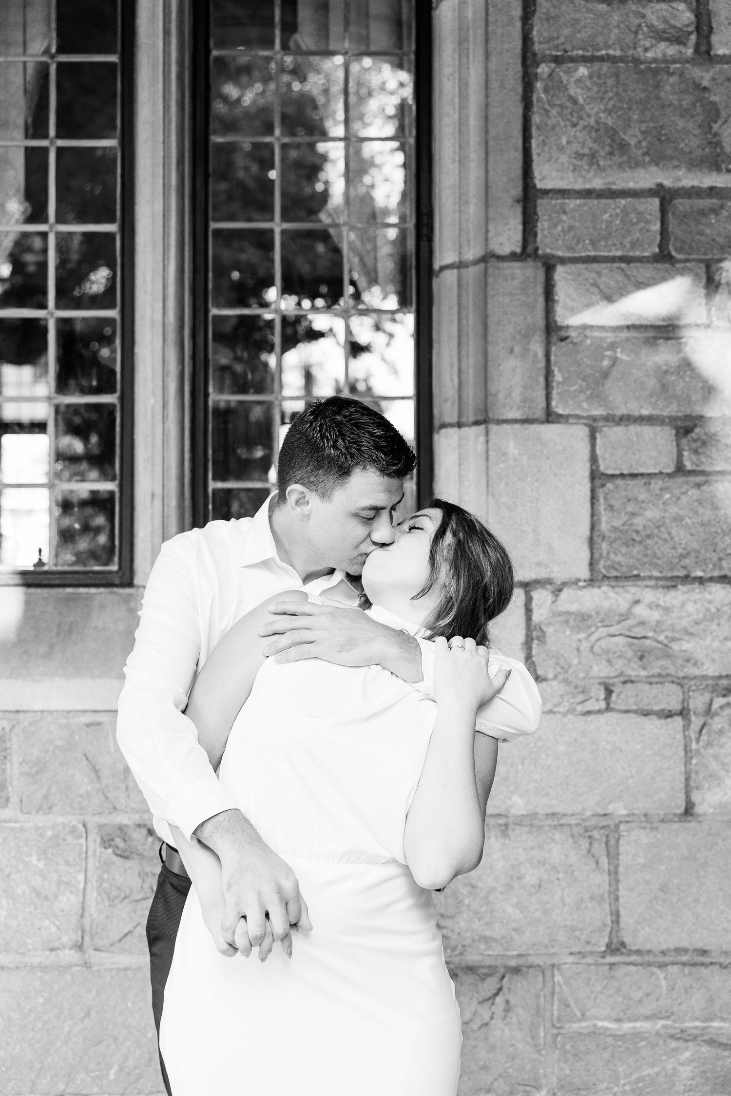 Engaged couple kissing at the University of Michigan Law Quad engagement session in Ann Arbor, MI