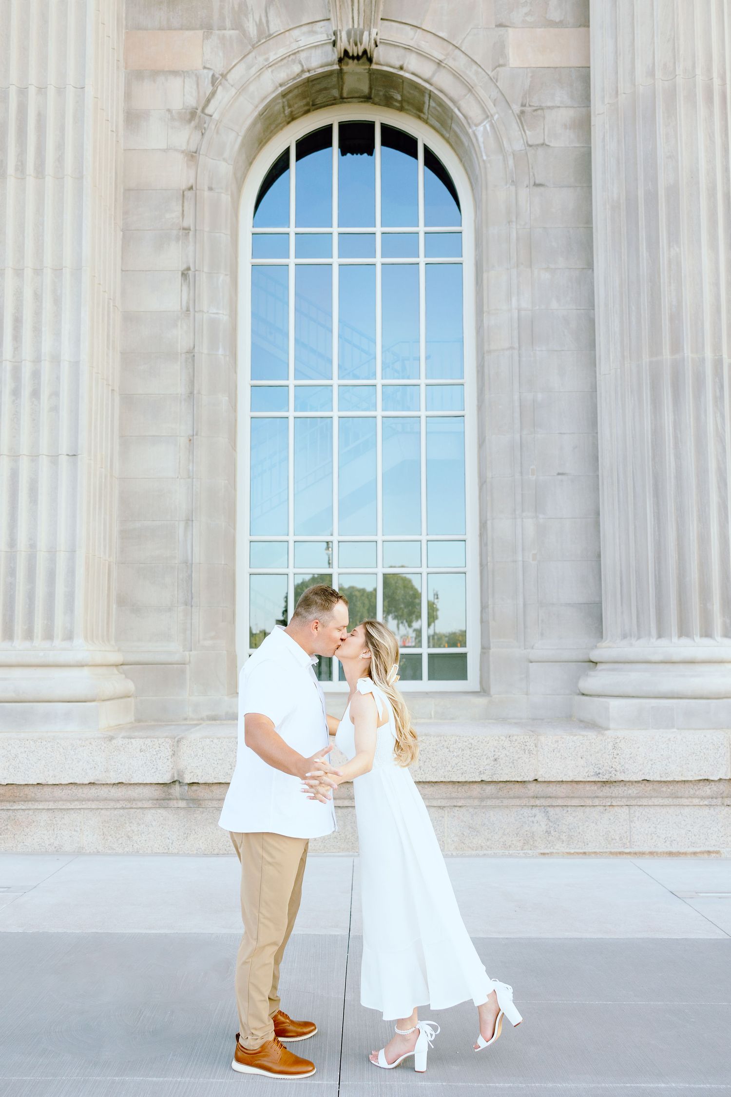 Engaged couple kissing at Michigan Central Station in Detroit, MI