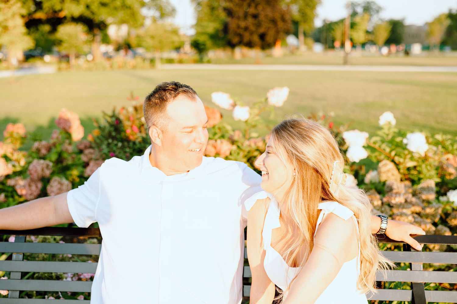 Engaged couple embracing on bench at Michigan Central Station in Detroit, MI