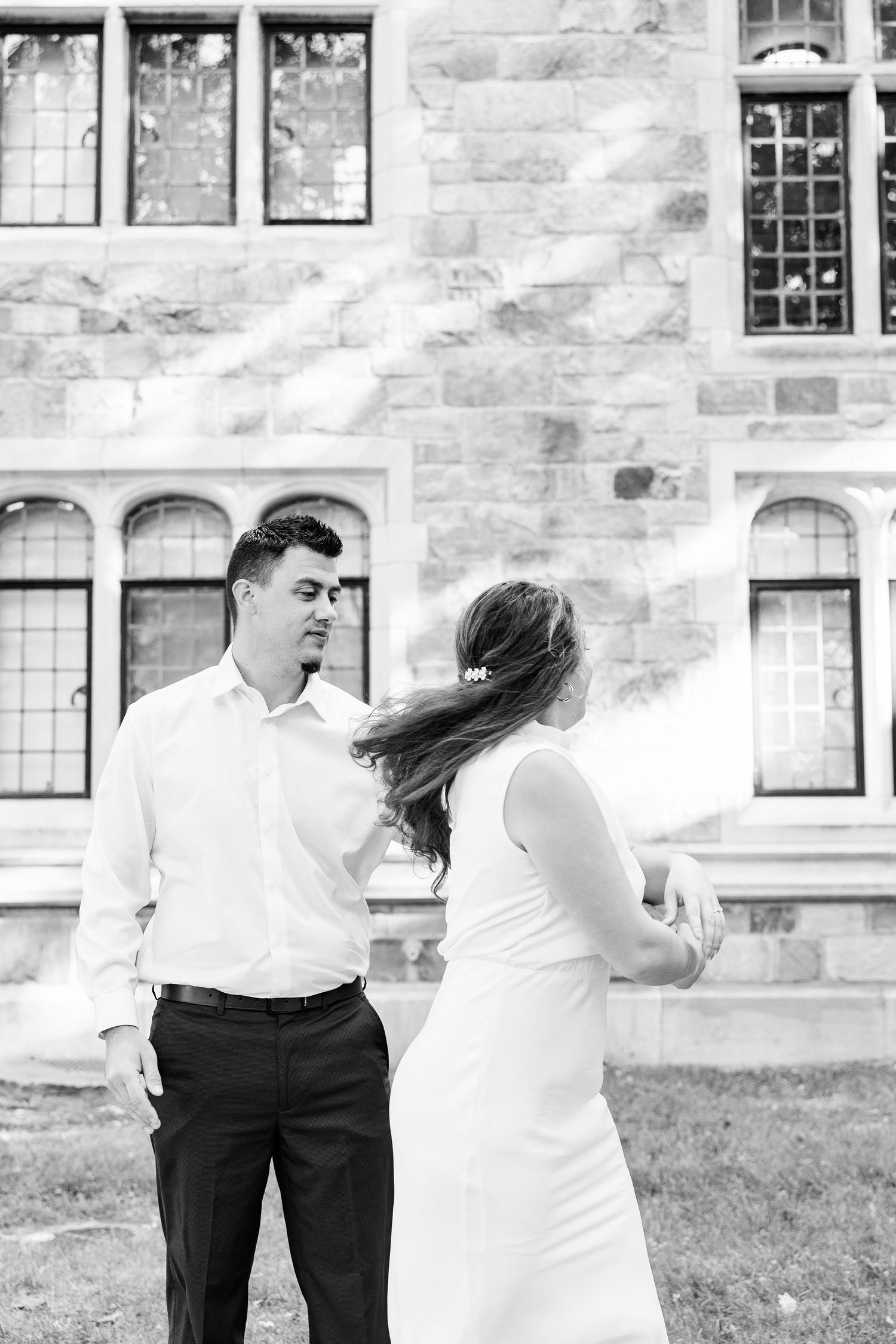 Engaged couple walking and holding hands at the UofM Law Quad engagement session in Ann Arbor, MI