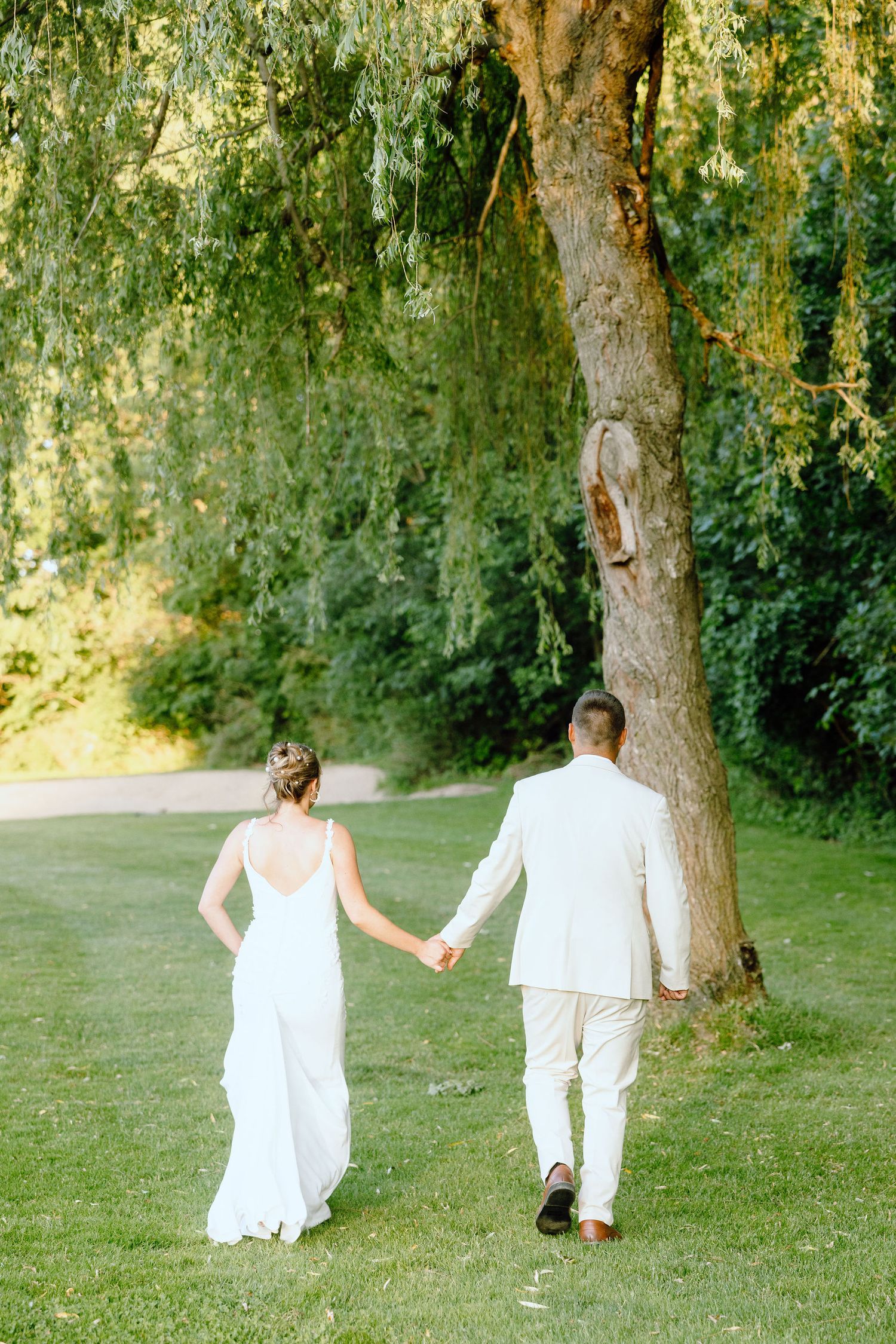 Married couple walking during golden hour at Lapeer Country Club wedding in Michigan