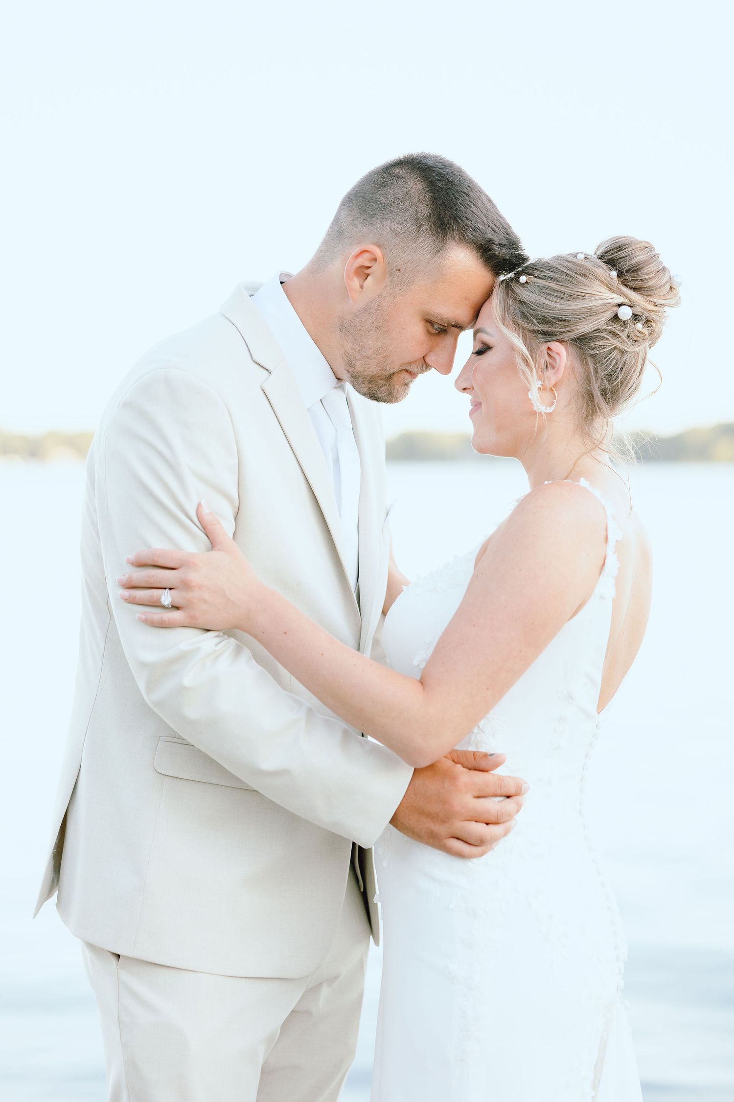 Married couple dipping on lake during golden hour at Lapeer Country Club wedding in Michigan
