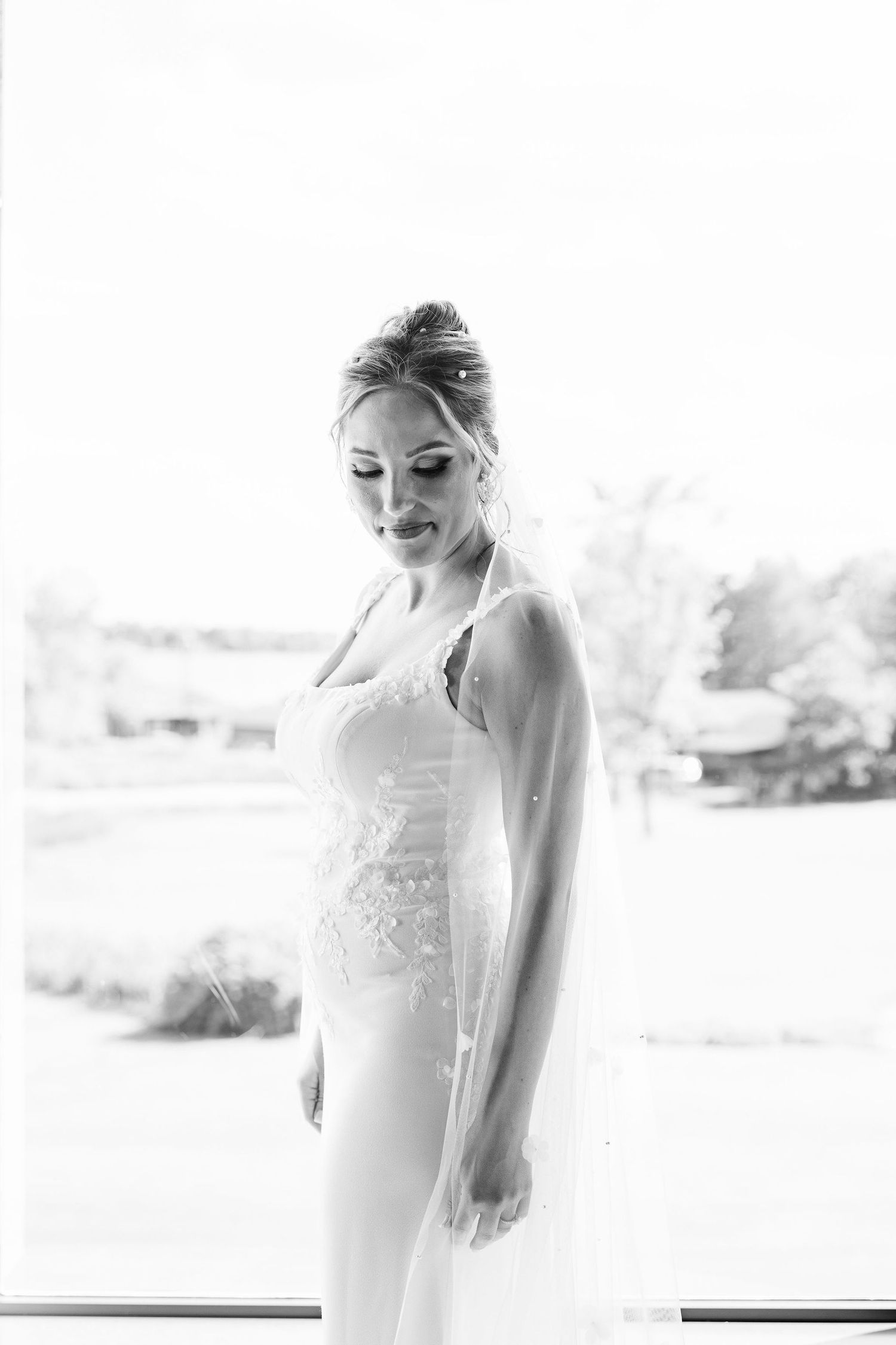 Bride portrait in front of window at Lapeer Country Club wedding in Michigan