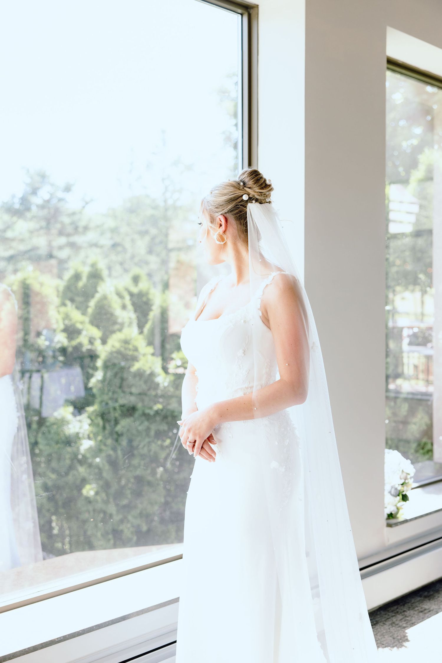 Bride portrait in front of window at Lapeer Country Club wedding in Michigan