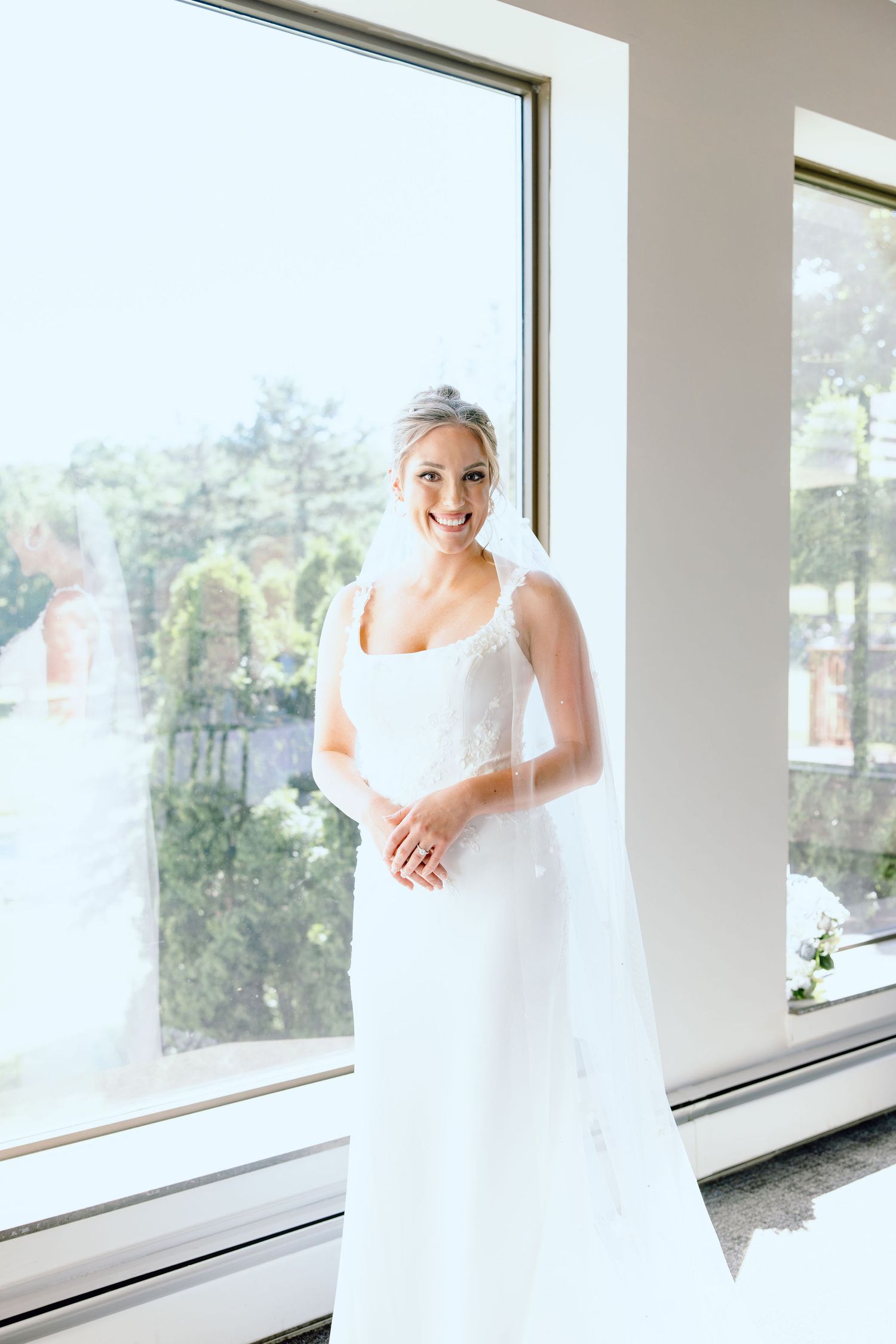 Bride portrait in front of window at Lapeer Country Club wedding in Michigan