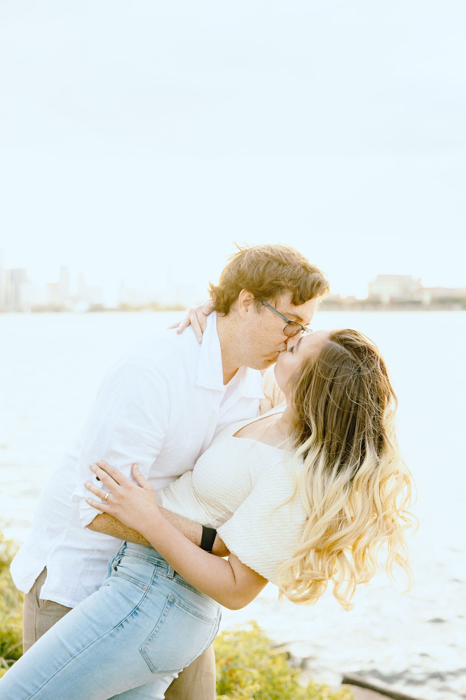 Engaged couple dipping and kissing at Belle Isle summer engagement session in Detroit, MI