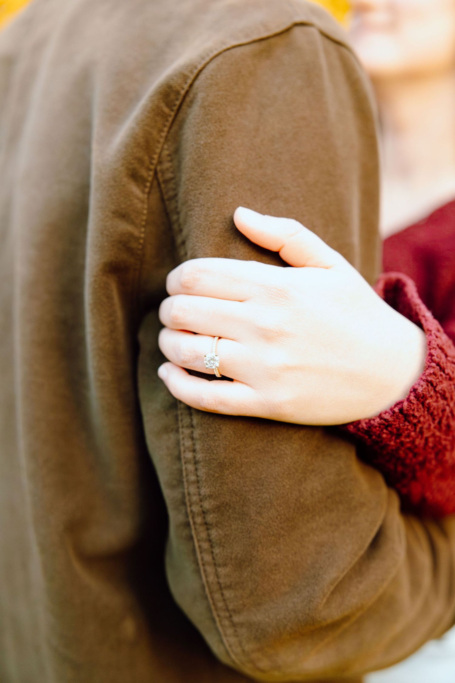 Detail photo of engagement ring at Nichols Arboretum in Ann Arbor, MI
