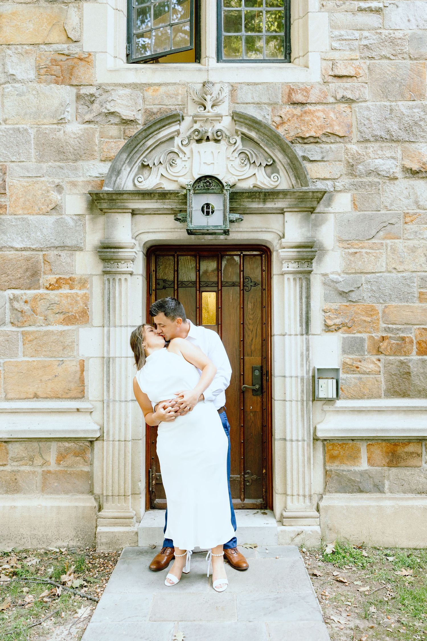 Engaged couple embracing at the University of Michigan Law Quad engagement session in Ann Arbor, MI