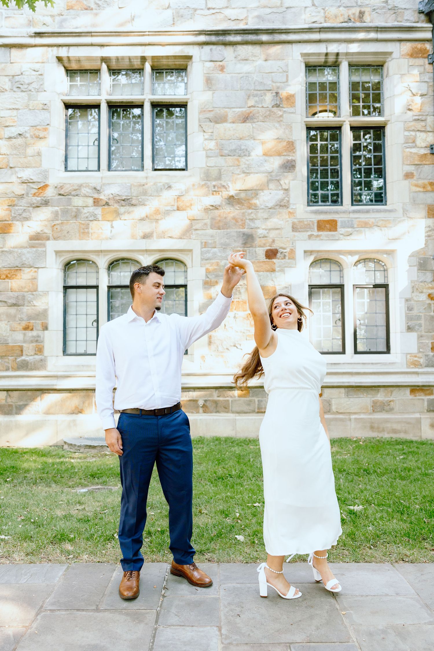 Engaged couple walking and holding hands at the UofM Law Quad engagement session in Ann Arbor, MI