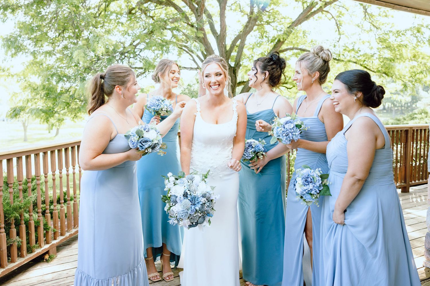 Bride and bridesmaids standing in a line at Lapeer Country Club wedding in Michigan