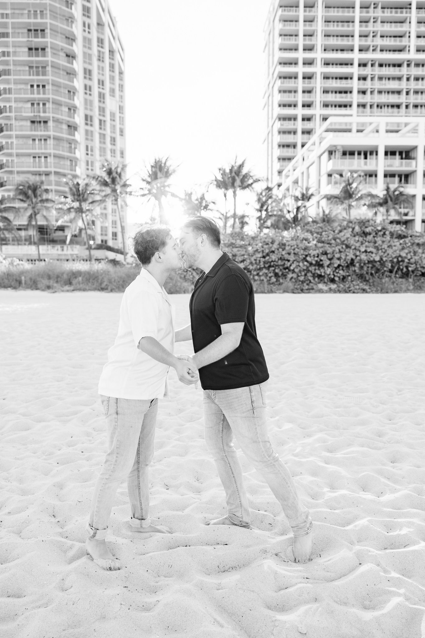 LGBTQ+ couple kissing and holding hands on North Miami Beach in Florida