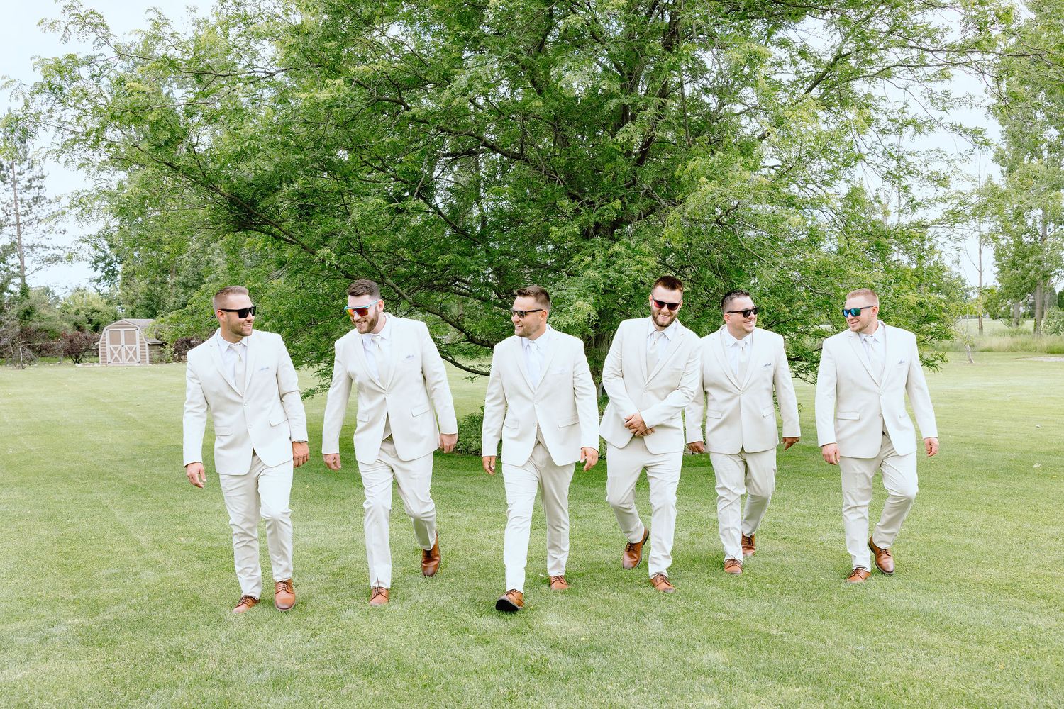 Groomsmen walking at Lapeer Country Club wedding in Michigan