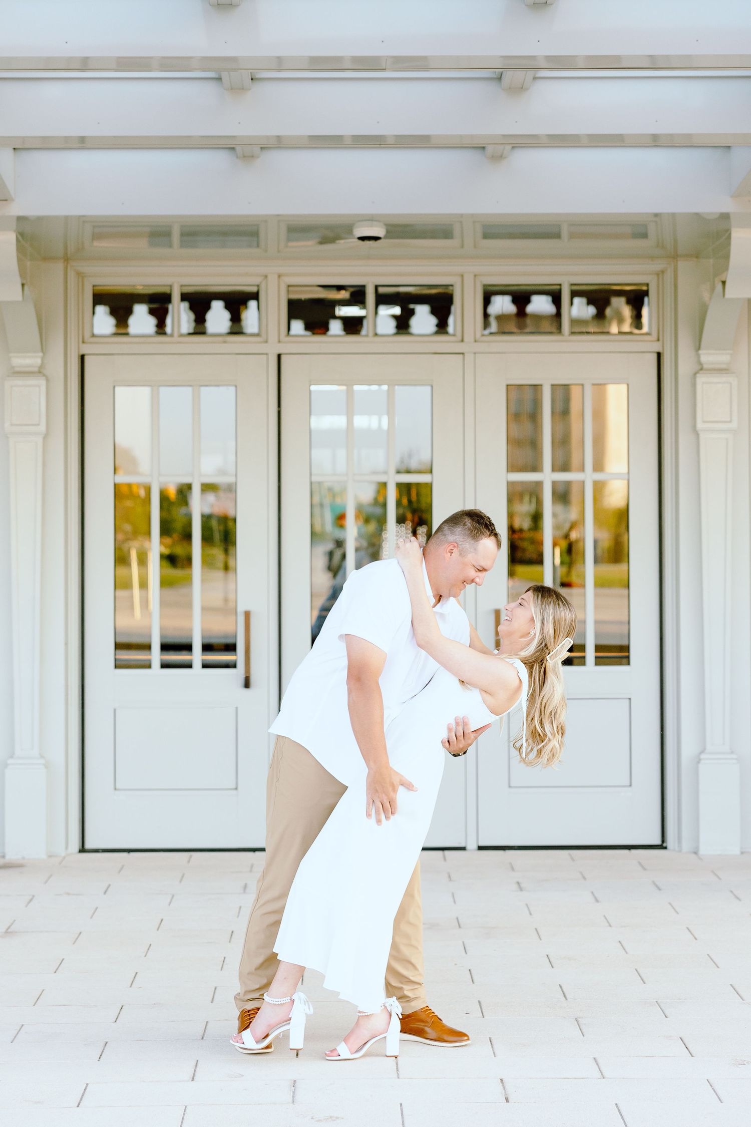 Engaged couple dipping at Michigan Central Station summer engagement session in Detroit, MI