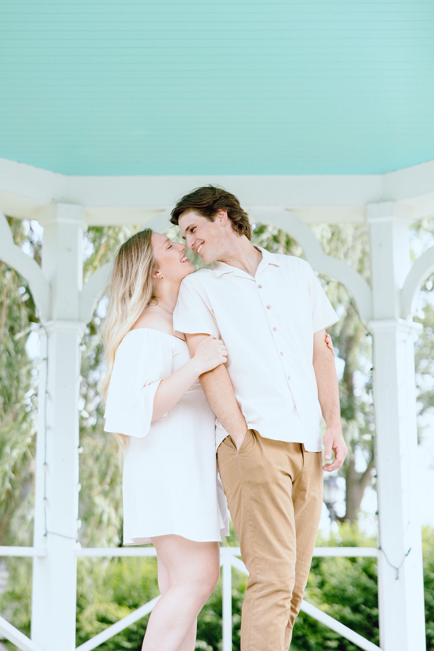 Engaged couple embracing at Greenfield Village in Dearborn, MI