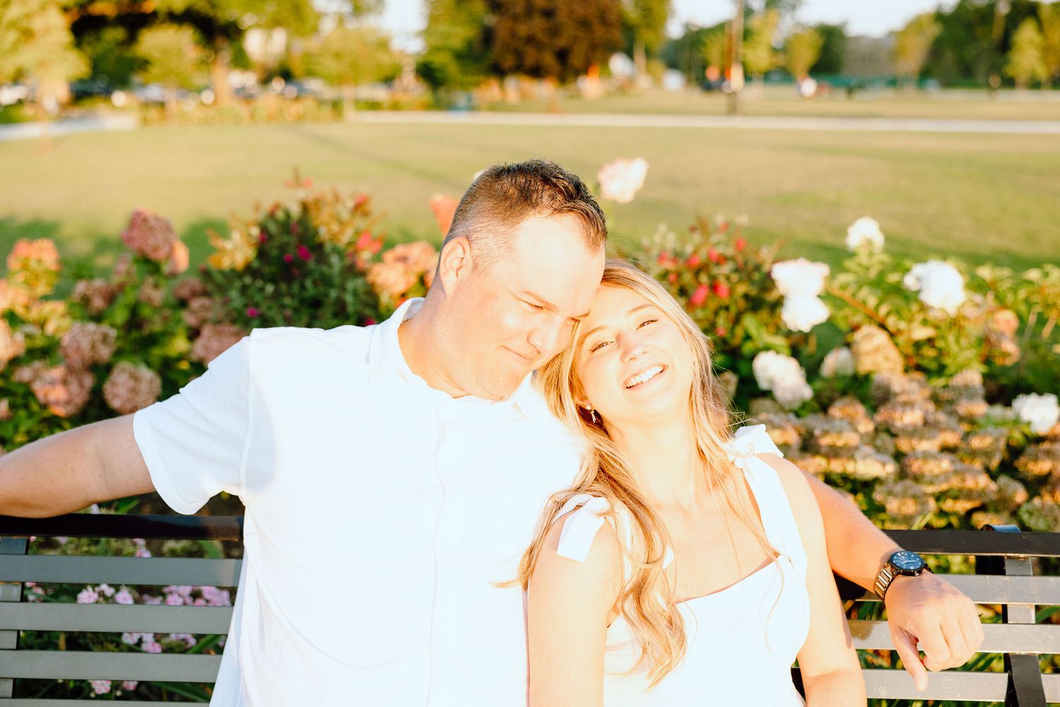 Engaged couple embracing on bench at Michigan Central Station in Detroit, MI