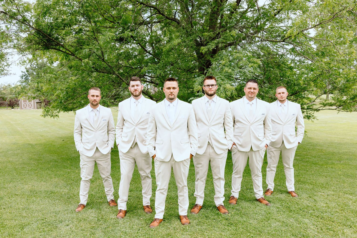 Groomsmen standing in V at Lapeer Country Club wedding in Michigan
