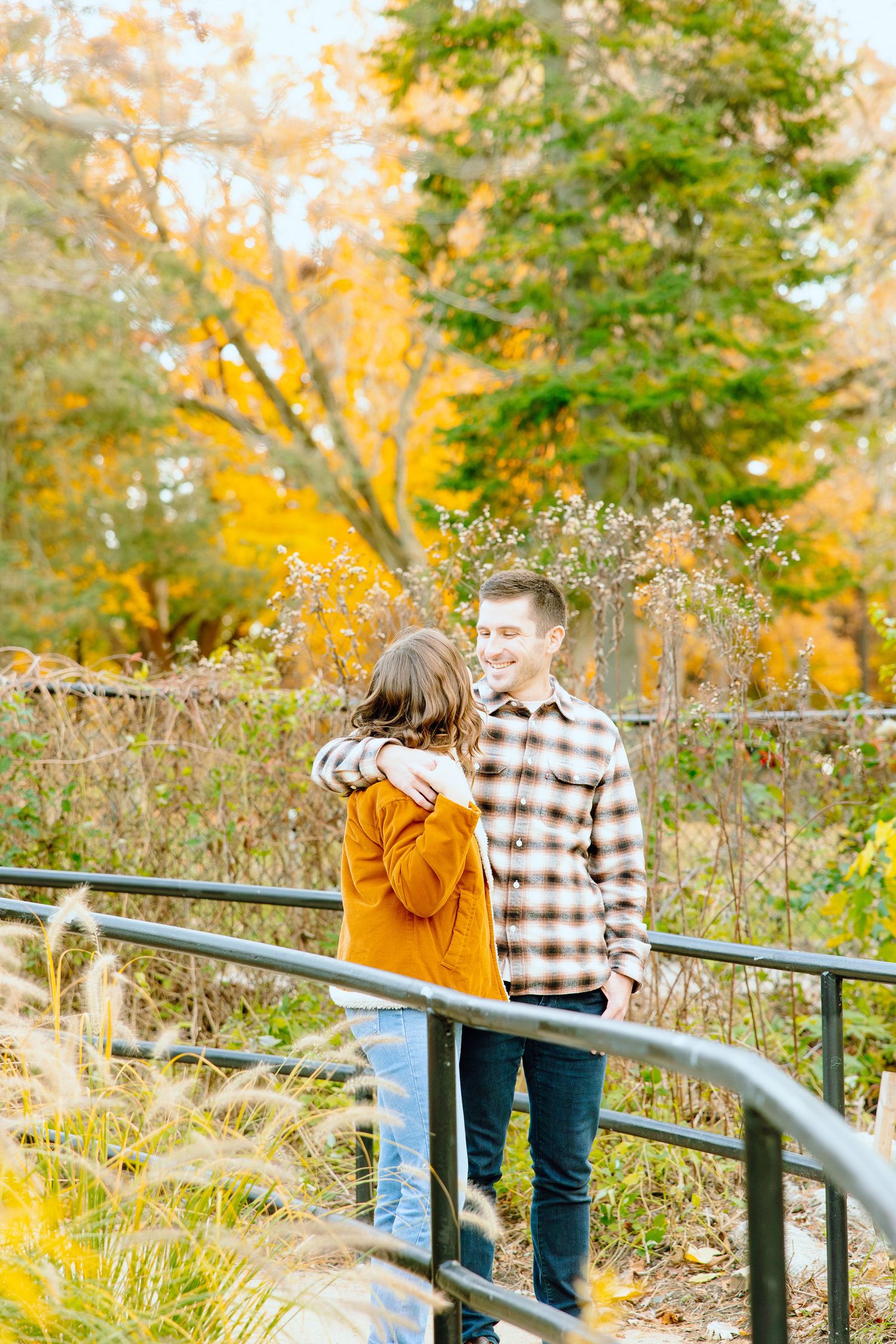 Engaged couple embracing at Nichols Arboretum fall engagement session in Ann Arbor, MI