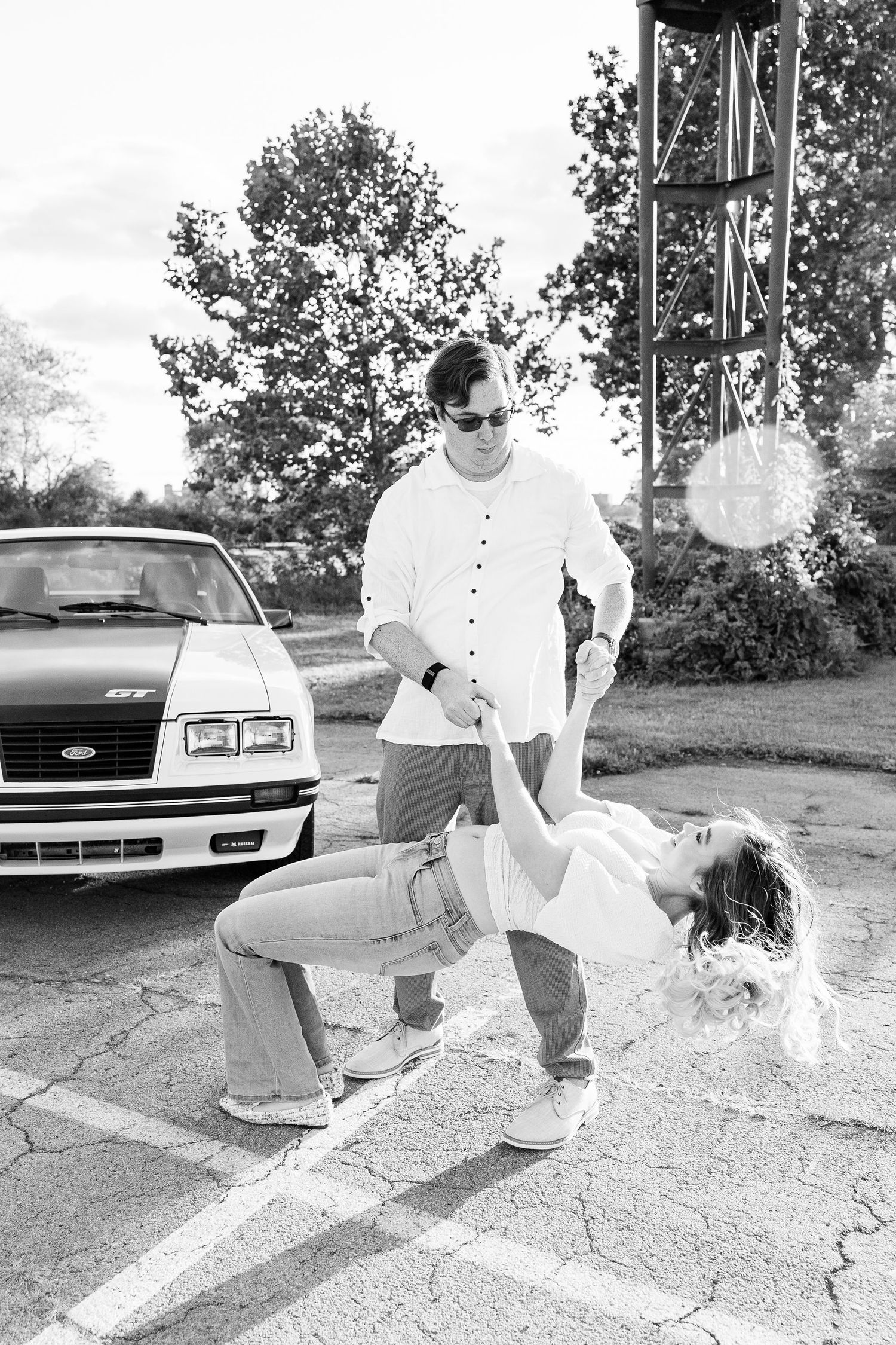 Engaged couple swing dancing at Belle Isle summer engagement session in Detroit, MI