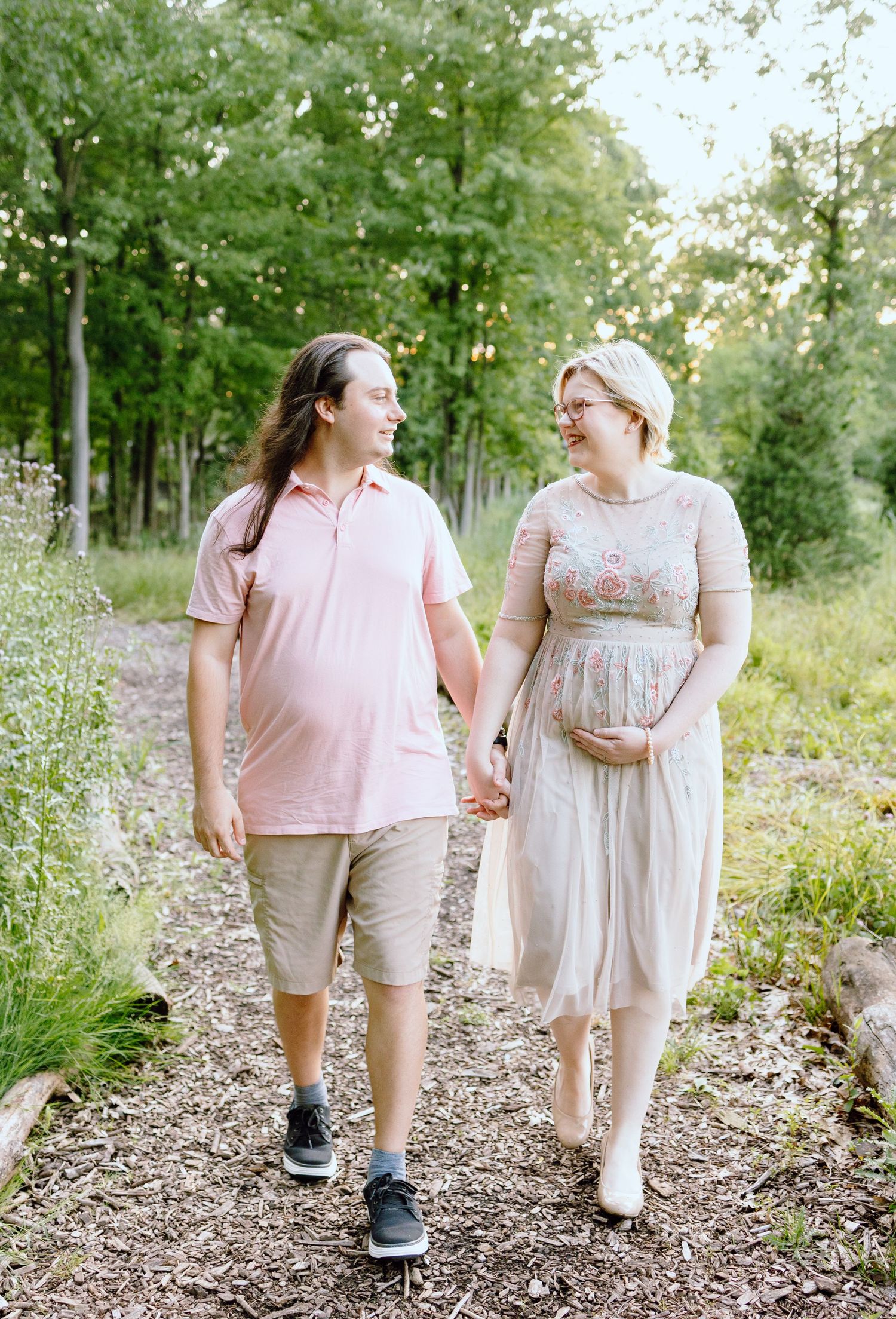 Pregnant couple walking in Beverly Hills Village Park, MI