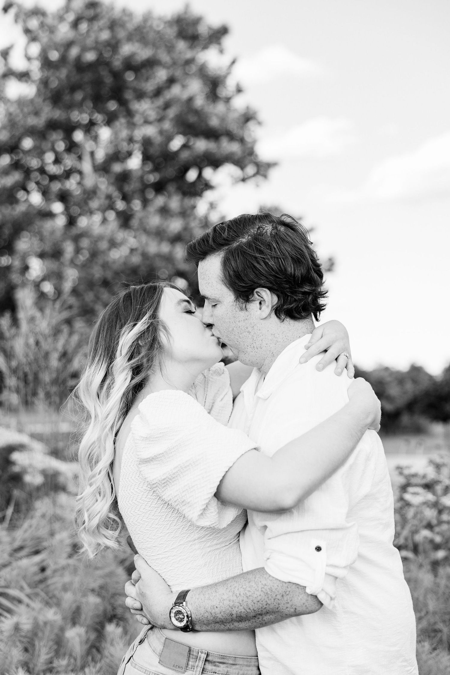 Engaged couple kissing at Belle Isle in Detroit, MI