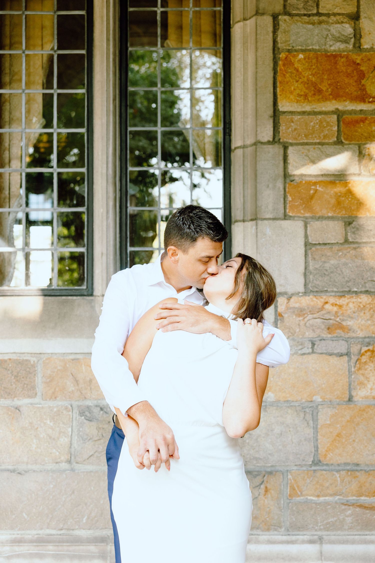 Engaged couple kissing at the University of Michigan Law Quad engagement session in Ann Arbor, MI
