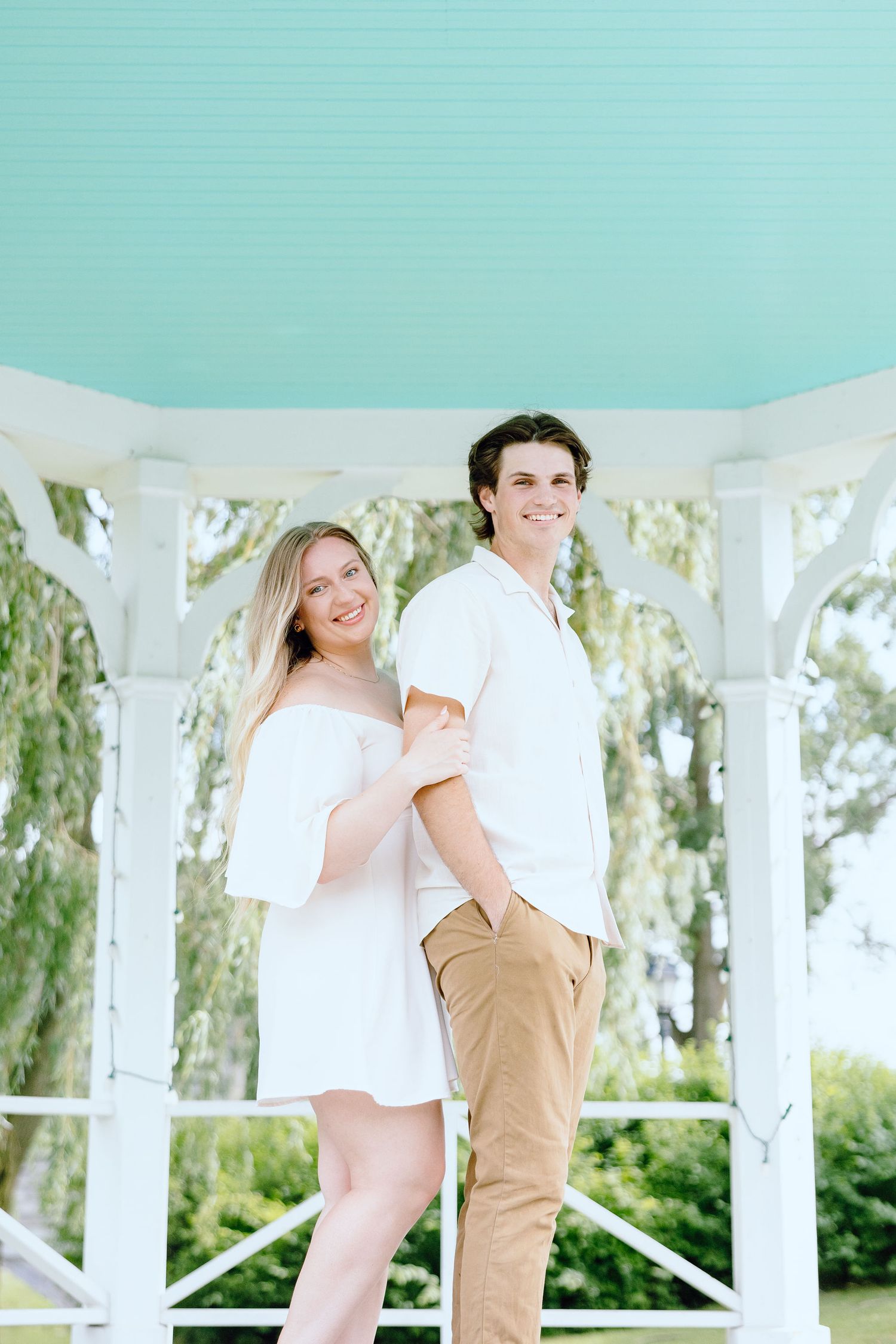 Engaged couple embracing at Greenfield Village in Dearborn, MI